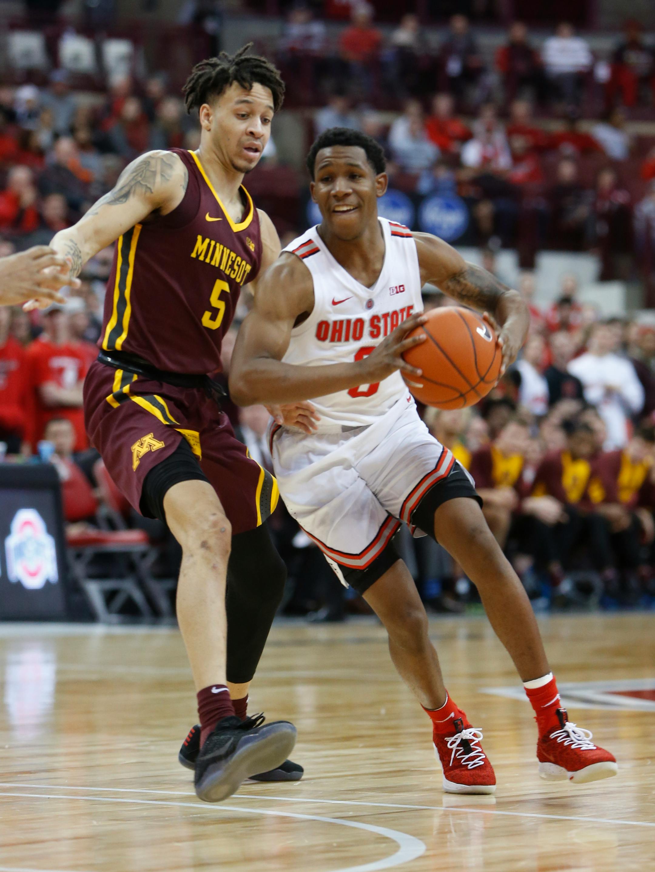 Ohio State's C.J. Jackson, right, passes the ball as Minnesota's Amir Coffey defends during the second half of an NCAA college basketball game Sunday, Dec. 2, 2018, in Columbus, Ohio. Ohio State beat Minnesota 79-59. (AP Photo/Jay LaPrete)