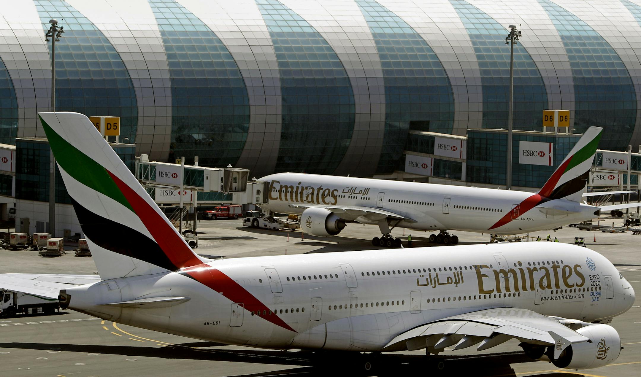 FILE- In this May 8, 2014 file photo, Emirates passenger planes are in use at Dubai airport in United Arab Emirates. Dubai Airports said Monday it plans to add 10 more A380 gates with air bridges at Dubai International Airport's Concourse C. That will leave the airport with a world record 47 gates designed for the aircraft. (AP Photo/Kamran Jebreili, File) ORG XMIT: ARE101