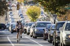 Cyclists and traffic move up Marshall Avenue eastbound in St. Paul during rush hour. ] LEILA NAVIDI &#x2022; leila.navidi@startribune.com BACKGROUND I