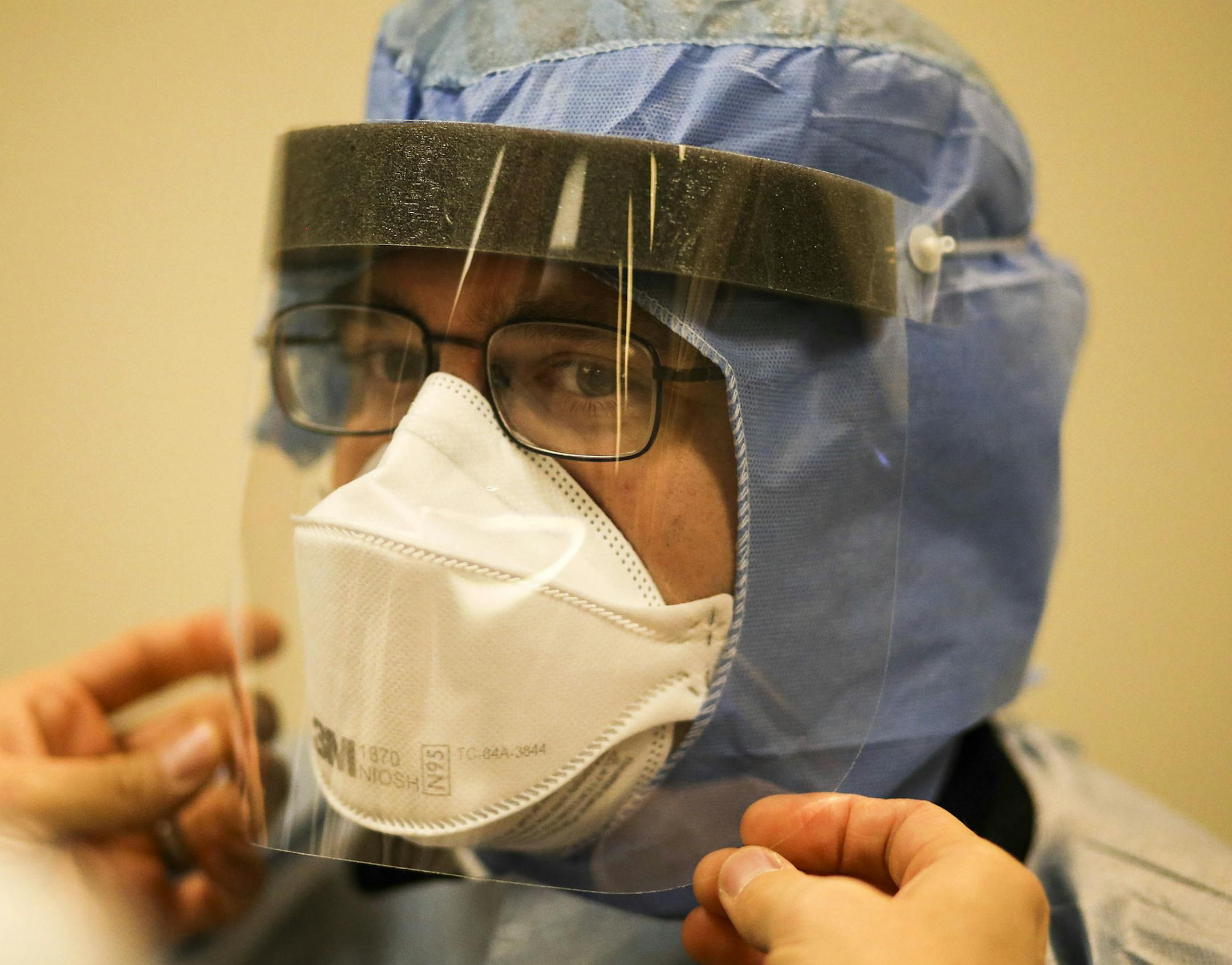 Allina EMS first responders received training on the latest protocol for handling future patients possibly infected with Ebola Tuesday, Oct. 28, in Mounds View, MN. Here, Allina paramedic Jake Shepard gets help putting on a face shield as Allina first responders learned about procedures for using personal protective equipment in suspected Ebola patients. ](DAVID JOLES/STARTRIBUNE)djoles@startribune.com As national, state and local leaders debate quarantines and other more aggressive measures to