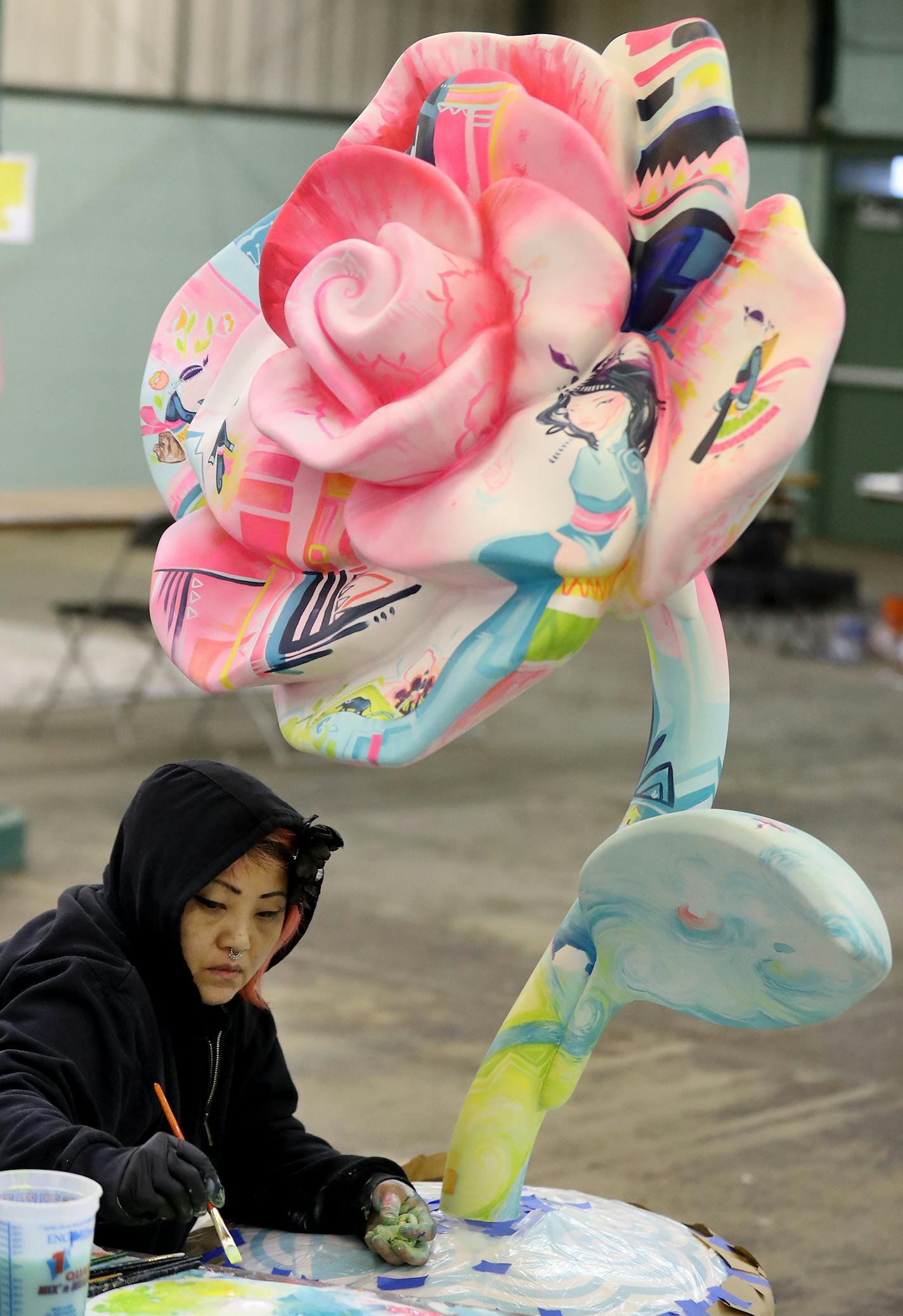 Artist Kao Lee Thao works on her rose, "Hmong Story Cloth," in the Merchandise Mart building of the State Fairgrounds in Falcon Heights.