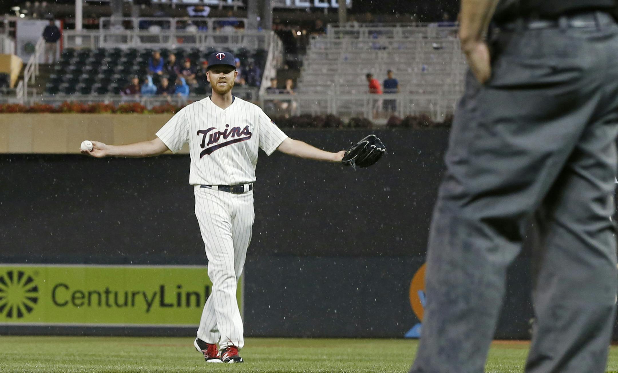 Minnesota Twins pitcher Michael Tonkin throws his arms wide, questioning the decision to halt play for rain in the 11th inning of the Twins' baseball game against the Cleveland Indians on Saturday, July 16, 2016, in Minneapolis. (AP Photo/Jim Mone)