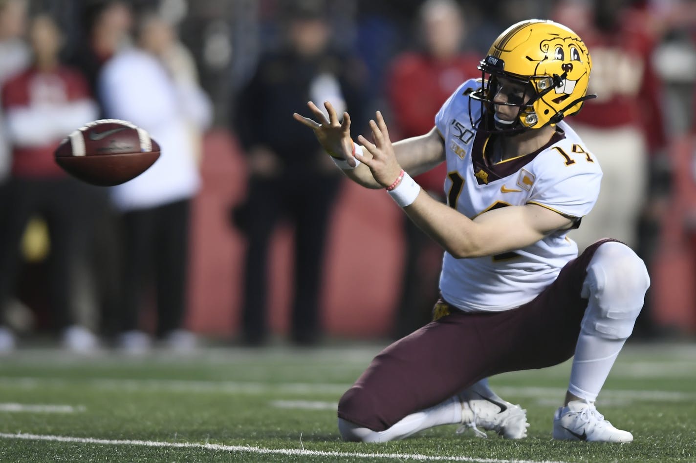 Gophers punter Casey O'Brien (14) caught the ball while setting up for an extra point in the fourth quarter against Rutgers.