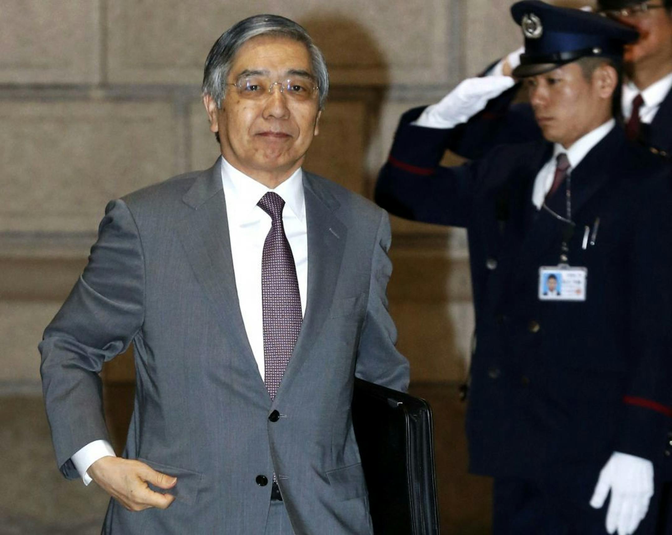 Bank of Japan Gov. Haruhiko Kuroda, left, arrives for a meeting at the BOJ's head office in Tokyo, Wednesday, April 8, 2015. Two years after launching a bazooka of ultra-lavish monetary easing, Bank of Japan Gov. Kuroda has made only fitful progress toward the goal of the 2 percent inflation rate he and Prime Minister Shinzo Abe said was needed to jolt the world�s No. 3 economy out of its deflationary rut. (AP Photo/Kyodo News) JAPAN OUT, MANDATORY CREDIT