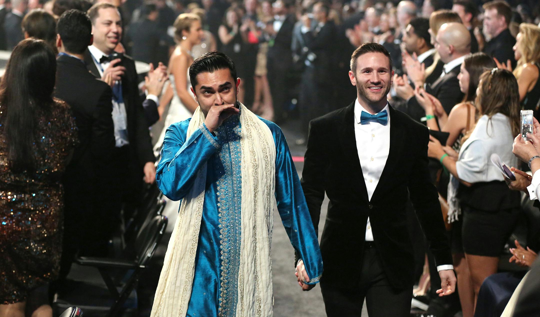 Audience members participate in a same sex wedding during a performance of "Same Love" by Macklemore and Ryan Lewis at the 56th annual Grammy Awards at Staples Center on Sunday, Jan. 26, 2014, in Los Angeles. (Photo by Matt Sayles/Invision/AP) ORG XMIT: MIN2014012711374033