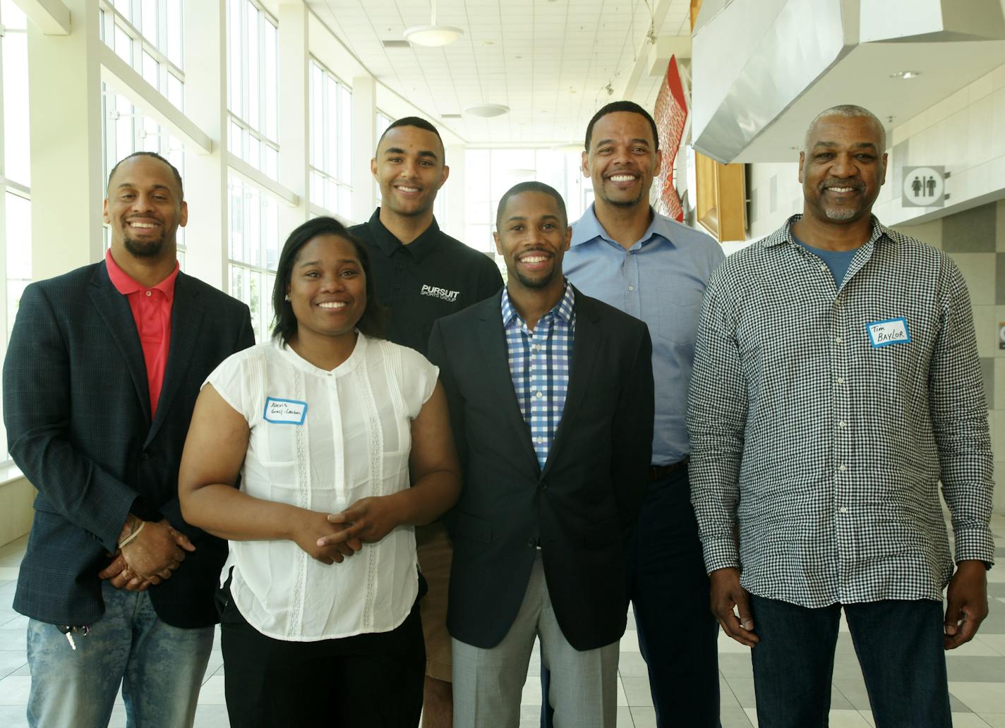 Former professional athletes told kids and coaches to learn early about personal finance and how to save and spend wisely, regardless of income, at a forum sponsored by Romone Penny's Pursuit Sports Group at the Colin Powell Youth Center in Minneapolis. Pictured (clockwise) are Zacharia Oluwabankole Babington-Johnson, director of audit at Thor Construction; Realtor and investor Daniel Coleman; John Thomas of Lifetime Fitness; developer Tim Baylor, Romone Penny and high school coach Alexis Gray,