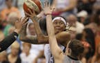 The Lynx' Seimone Augustus looked for a shot over the defense of the Stars' Samantha Logic in the third quarter Sunday night at Target Center.