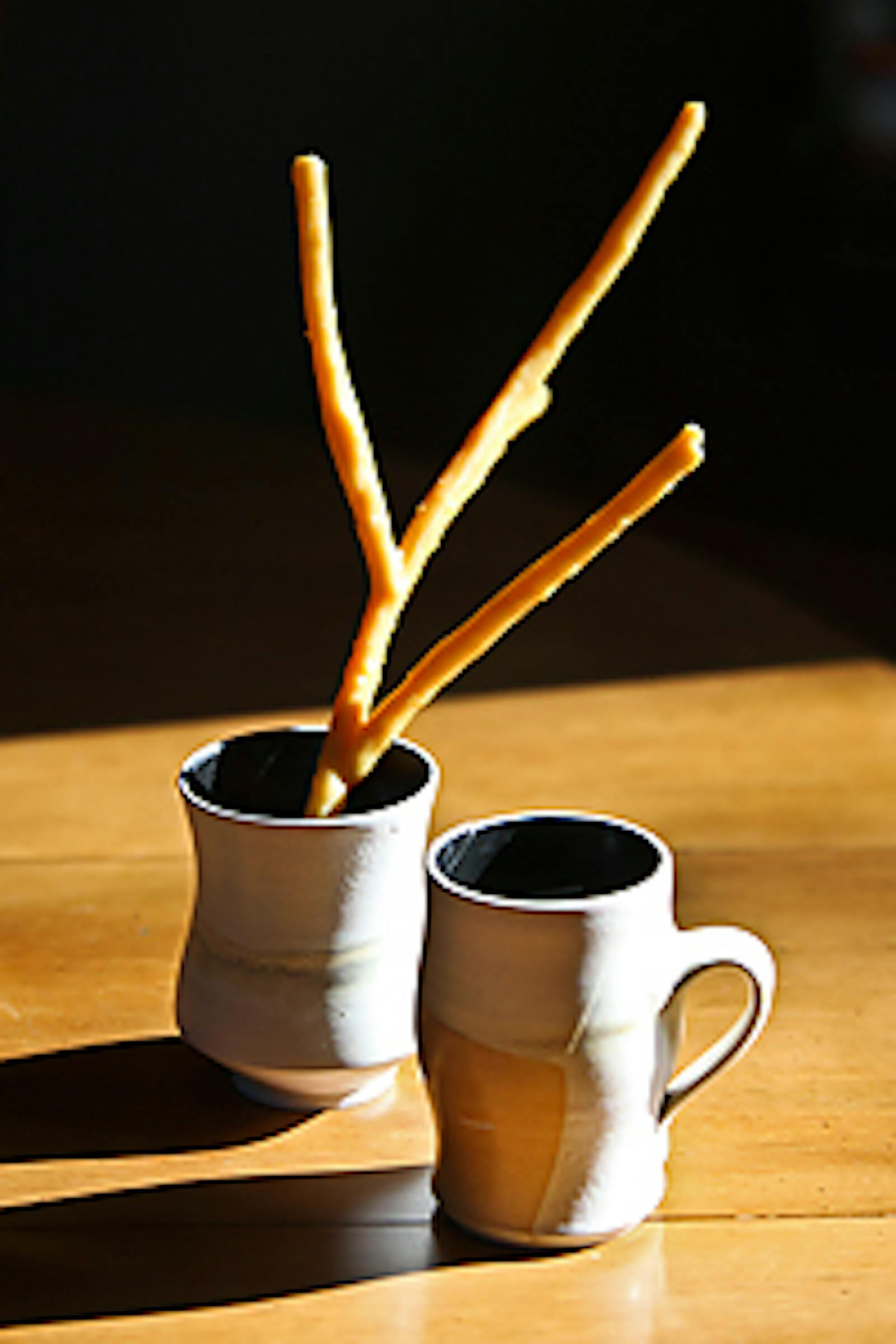 Ceramics by Maren Kloppmann and the twig is by Aaron Dysart. Nick Zimet and Liz Sanborn received these as a part of their CSA. The ceramics are Sanborn's favorite pieces.