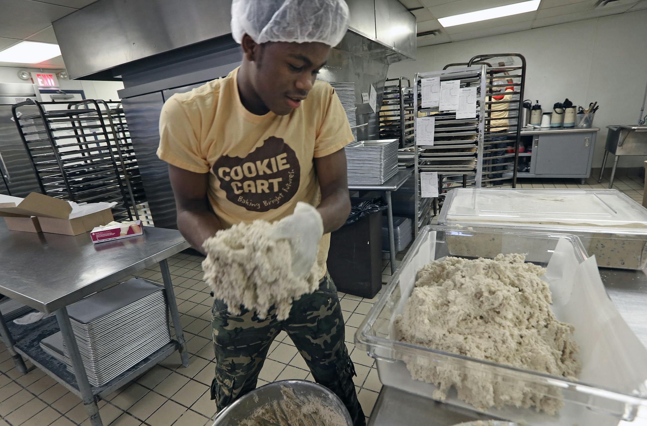 Ernest Holmes mixed up cookie dough at the Cookie Cart. The Cookie Cart is a fixture of north Minneapolis, a program that teaches high-school kids bakery and life skills. Photographed on 2/6/14.] Bruce Bisping/Star Tribune bbisping@startribune.com Ernest Holmes/source.