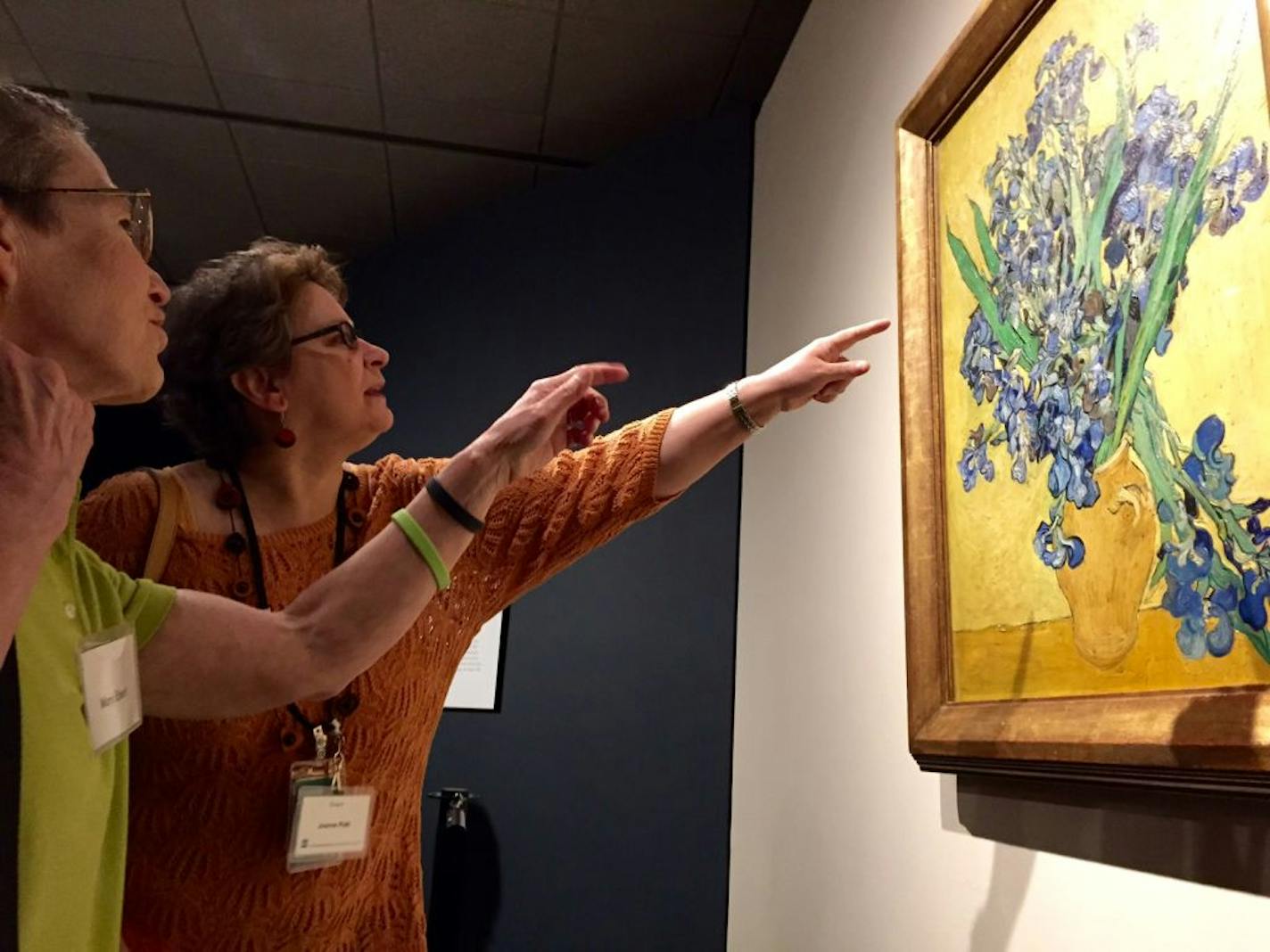 Mary Ebert, left, of Minneapolis and Joanne Platt, a docent at MIA, get a closer look at Van Gogh's 1890 painting "Irises, Saint-Rémy-de Provence" after it was unveiled Friday.