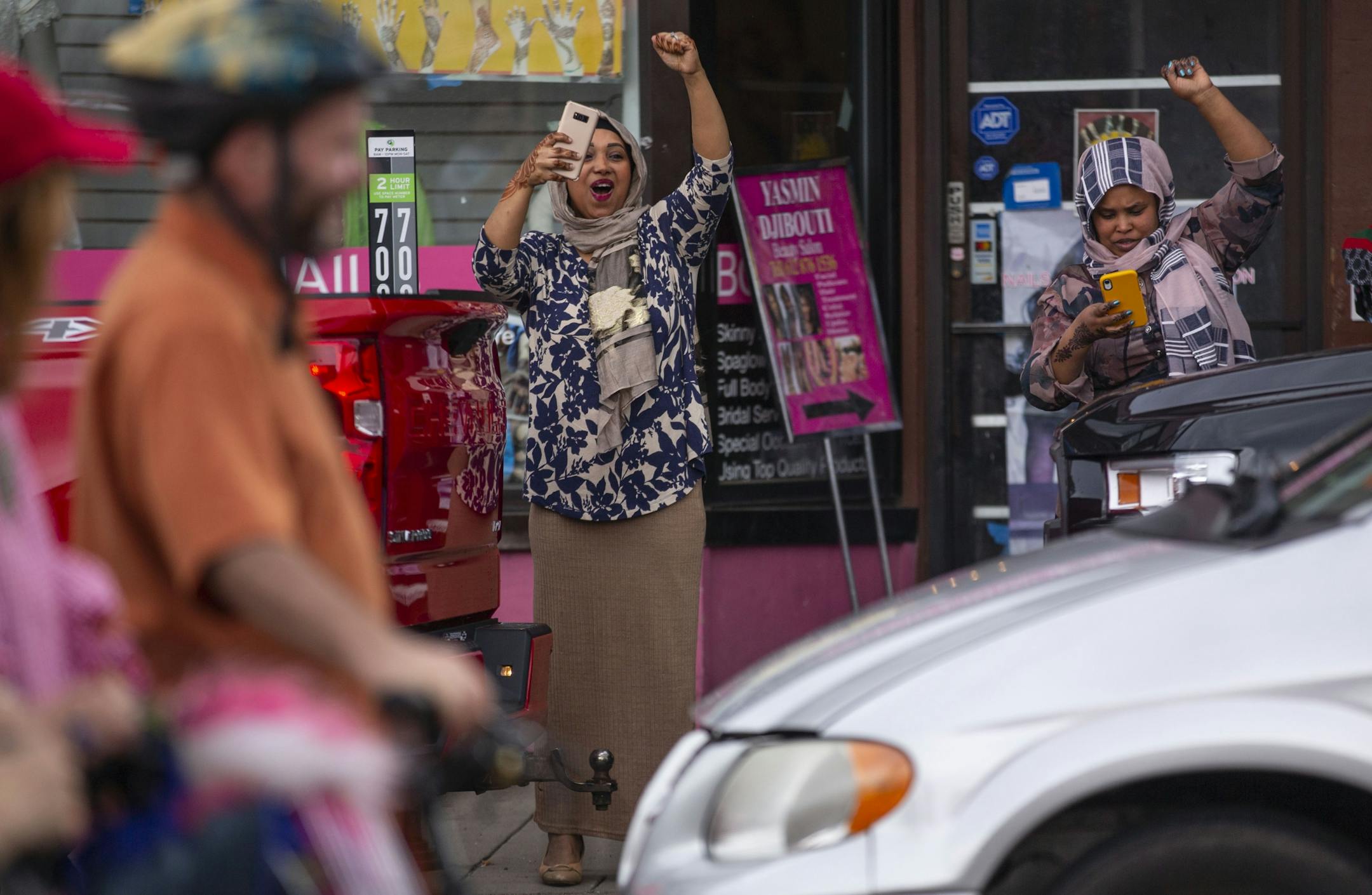 Two bystanders record and cheer on marchers as they move down the street. ALEX KORMANN ¥ alex.kormann@startribune.com Approximately 1,000 people marched through the streets of Minneapolis on Sunday June 30, 2019 protesting the treatment of migrants on the U.S. border. "Stop separating families, close the camps," said Mari Mansfield, an organizer for the event.