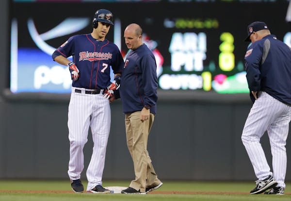 The Twins' Joe Mauer, left, was injured July 1 against Kansas City and remains on the disabled list.