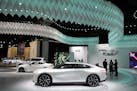 The Infinity Qs Inspiration concept car, bottom in white, is diplayed at the AutoMobility LA auto show Thursday, Nov. 21, 2019, in Los Angeles. (AP Ph
