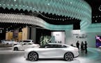 The Infinity Qs Inspiration concept car, bottom in white, is diplayed at the AutoMobility LA auto show Thursday, Nov. 21, 2019, in Los Angeles. (AP Ph