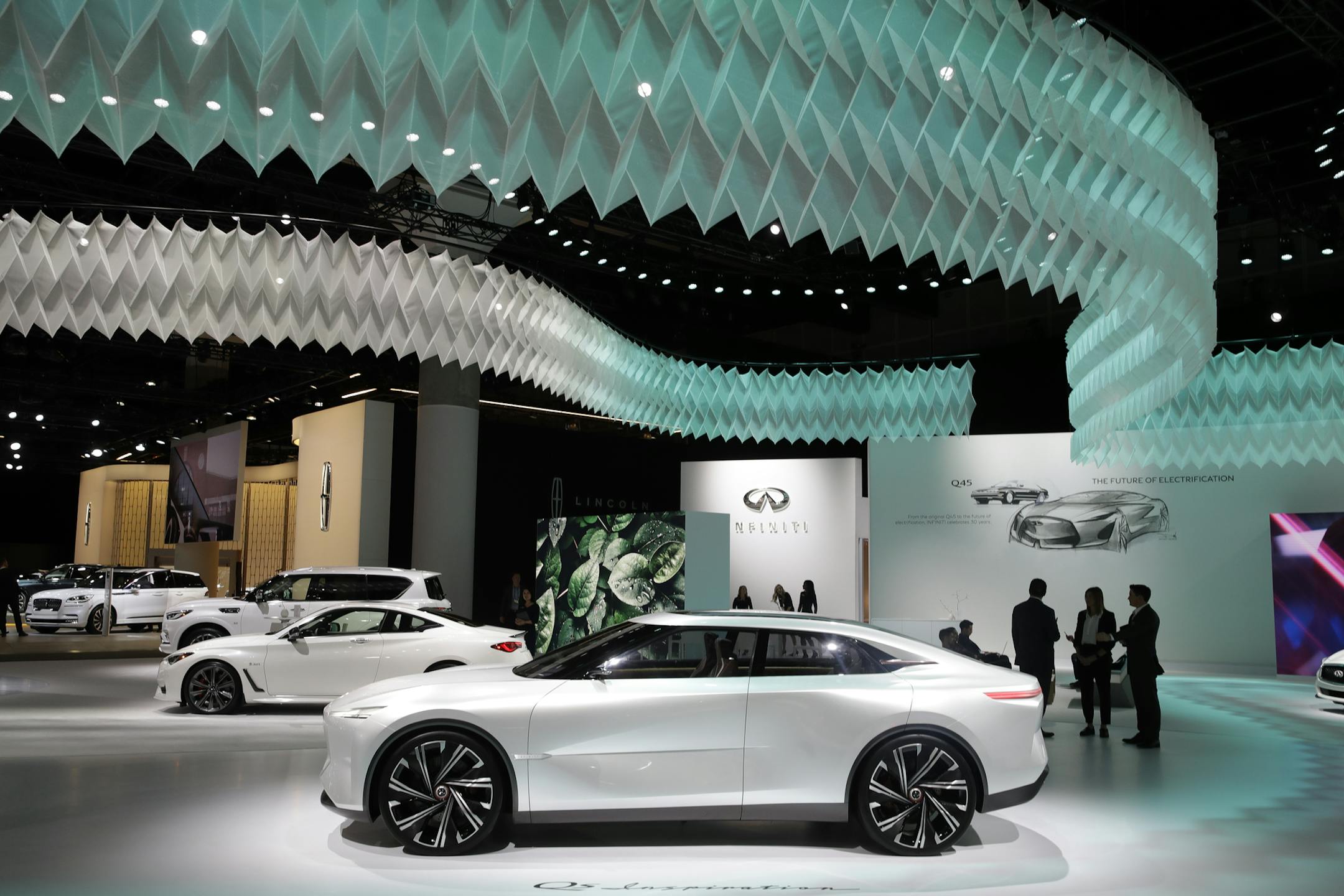 The Infinity Qs Inspiration concept car, bottom in white, is diplayed at the AutoMobility LA auto show Thursday, Nov. 21, 2019, in Los Angeles. (AP Photo/Marcio Jose Sanchez) ORG XMIT: CAMS133