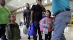 A group of immigrants from Honduras and Guatemala seeking asylum receive help the bus station after they were processed and released by U.S. Customs a