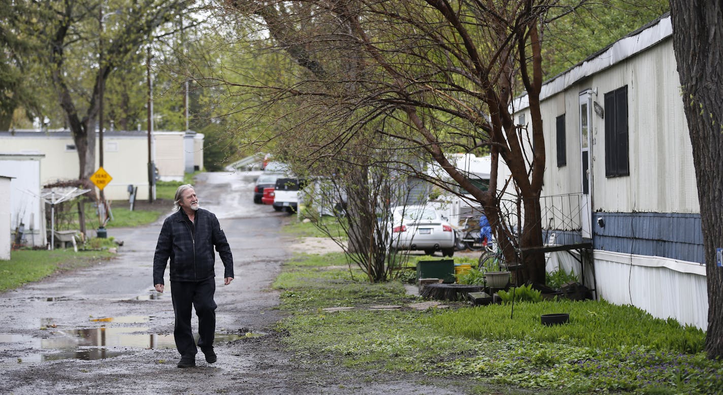 Bill McConnell walks through Lowry Grove. ] (Leila Navidi/Star Tribune) leila.navidi@startribune.com BACKGROUND INFORMATION: Thursday, April 28, 2016. Bill McConnell has lived in his manufactured home at Lowry Grove for 30 years. The owner of Lowry Grove, a manufactured home and RV park that is home to 100 families in St. Anthony, has received an offer to sell the park. Pending approval from the city of St. Anthony, all the residents of the park may be forced to move out of one of the few afford