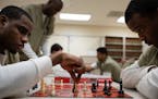 Cook County Jail detainees Jonathan Ivory, left, and Rashad Rowry practice before their next matches in a round-robin chess tournament with prisoners 
