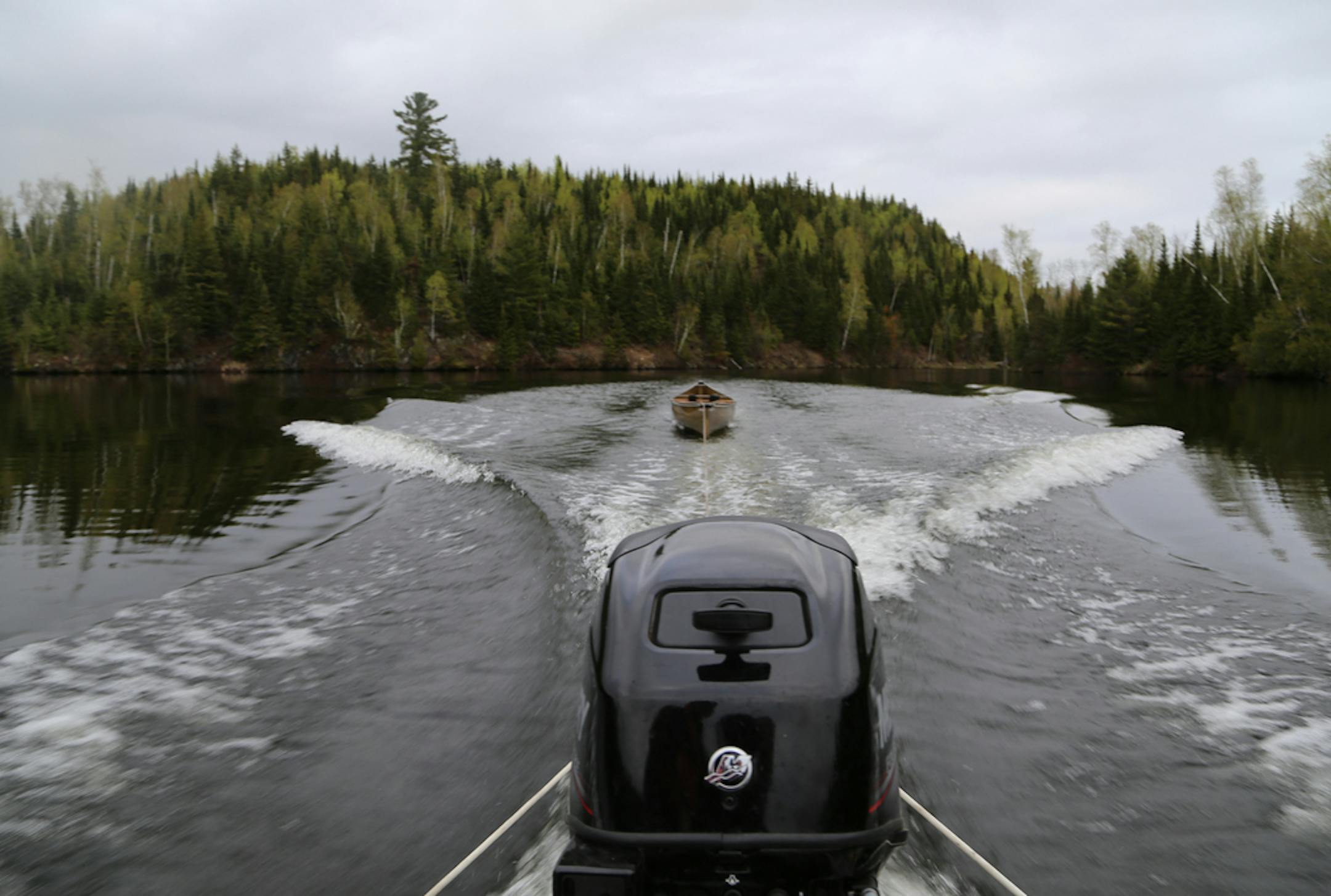 Dennis Anderson and his wife Jan rented a boat with a 25 horsepower outboard from Latourelle's Resort and Outfitters on Moose Lake near Ely. With the boat they pulled a canoe up Moose, Newfound and Sucker lakes, then left the boat at the portage into Ensign Lake, where they fished for the day. The motor route is one of the few remaining in the BWCA. ORG XMIT: MIN1905240955342262