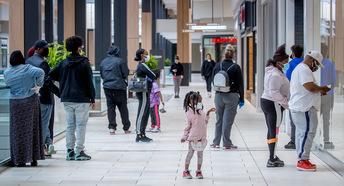 Shoppers made their way through Rosedale Center in Roseville on Monday as some of the stores opened for business.