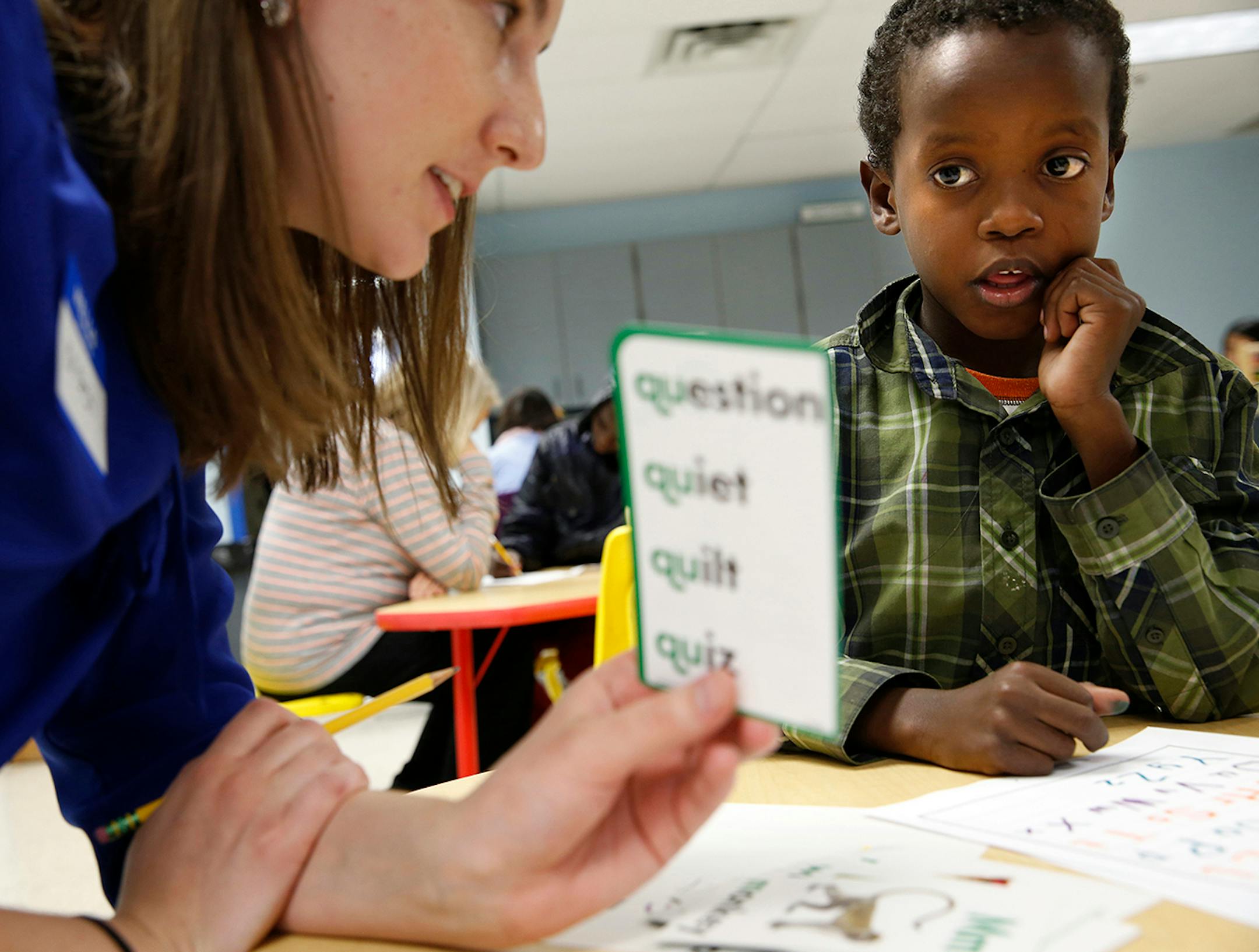 Somali immigrant Shukri Shukri, 9, works with tutor Kristen Hindt to learn to read, write and speak English at Mary's Place transitional apartments in downtown Minneapolis. ] LEILA NAVIDI leila.navidi@startribune.com / BACKGROUND INFORMATION: Tuesday, October 28, 2014. Minnesota has seen a marked uptick in new Somali refugee arrivals recently. The number of Somalis arriving directly from Africa has more than tripled in four years. But community leaders say there's also been an increase in so-cal