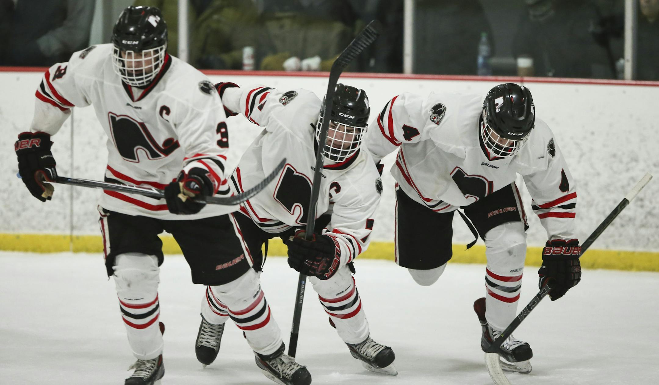 Lakeville North's Nick Poehling, center, skated back to the bench after he scored on Duluth East in the second period Tuesday night in Lakeville. Poehling's brothers and line mates, Jack, left, and Ryan earned assists on the goal. (Jeff Wheeler, Star Tribune)