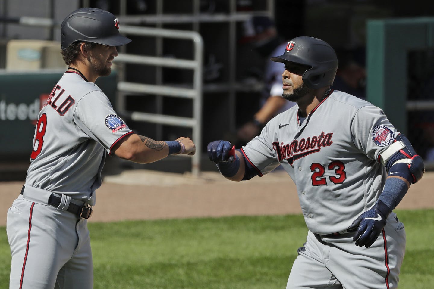 Minnesota Twins' Nelson Cruz, right, celebrates with Aaron Whitefield after hitting a three-run home run during the eighth inning of a baseball game against the Chicago White Sox in Chicago, Sunday, July 26, 2020. (AP Photo/Nam Y. Huh)