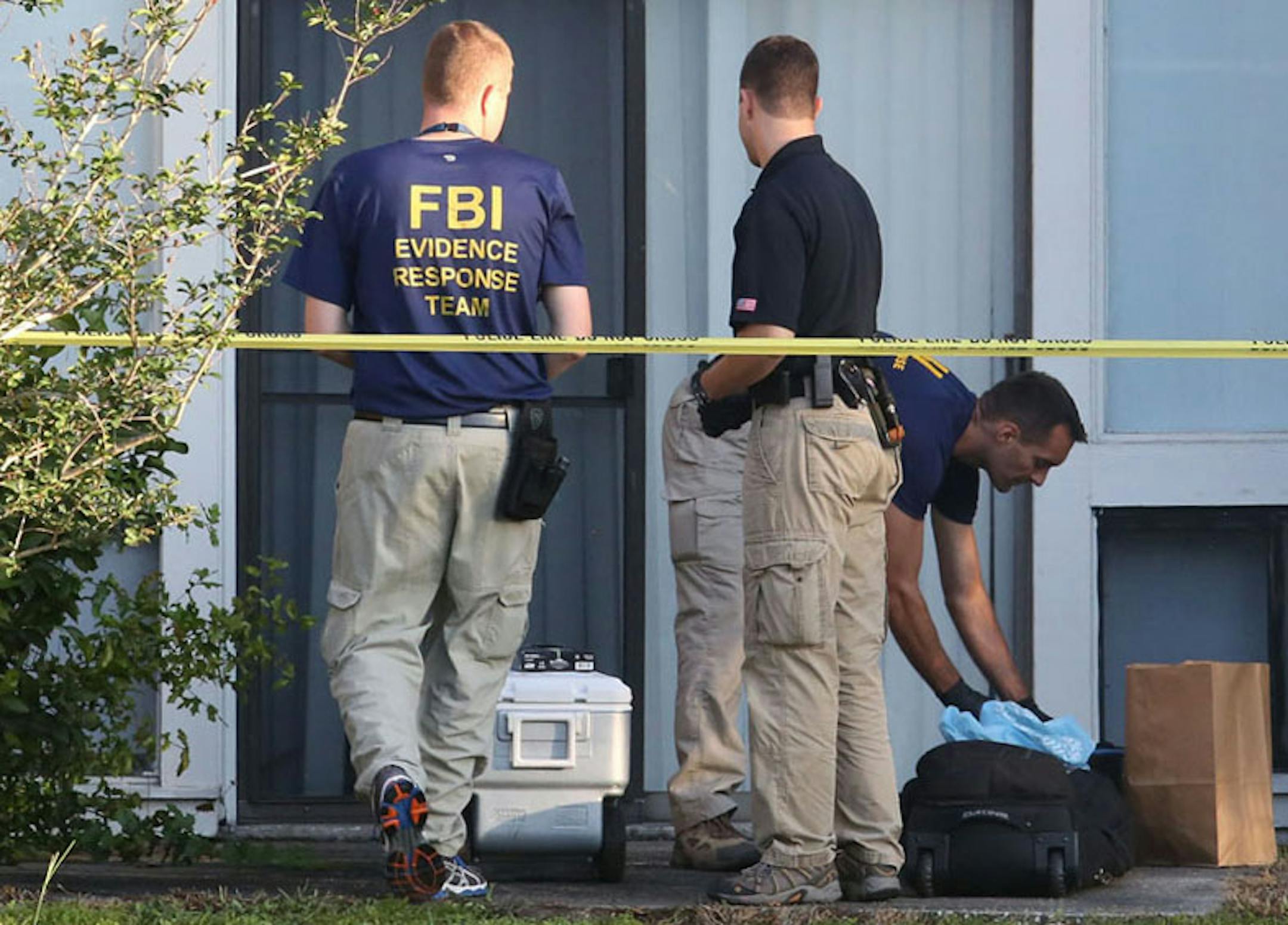 FBI evidence response team gather in front of an apartment Wednesday, in Orlando, Fla., after an FBI agent shot and killed a man who was questioned in connection with the Boston Marathon bombings.