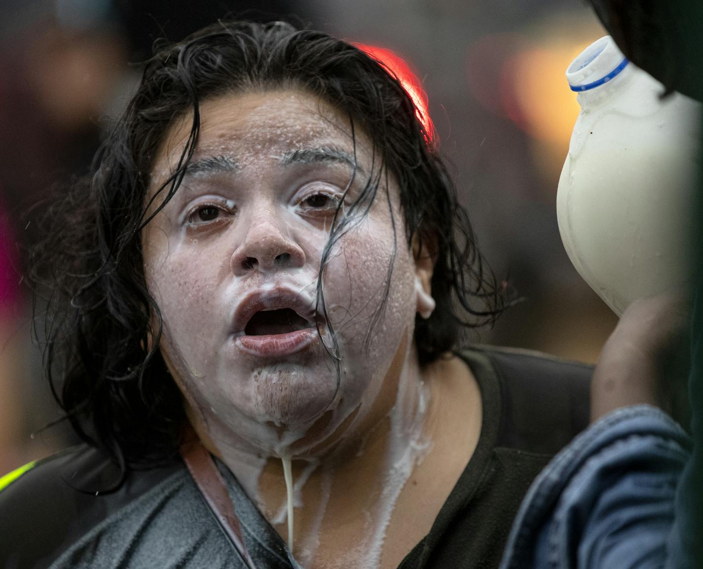 A protester was doused with milk after exposure to percussion grenades and tear gas at the Minneapolis 3rd Police Precinct. ] CARLOS GONZALEZ • cgonzalez@startribune.com – Minneapolis, MN – May 26, 2020, Police Protest - man died after a confrontation with Minneapolis on Monday evening. A bystander video that started circulating sometime after the incident appeared to show the man pleading with officers that he couldn't breathe - George Floyd