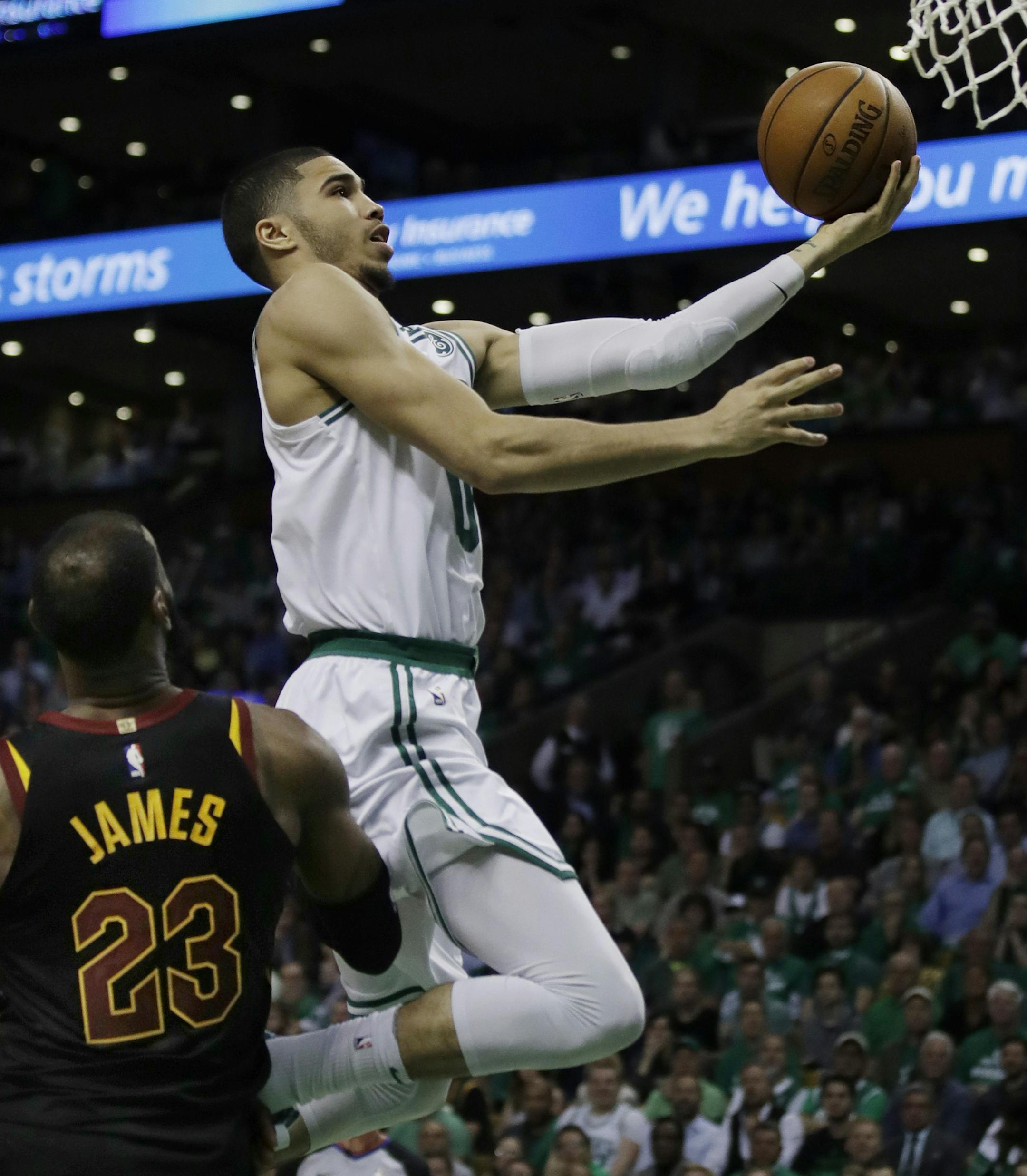 Boston Celtics forward Jayson Tatum (0) goes to the basket over Cleveland Cavaliers forward LeBron James (23) during the fourth quarter of Game 5 of the NBA basketball Eastern Conference finals Wednesday, May 23, 2018, in Boston. (AP Photo/Charles Krupa)