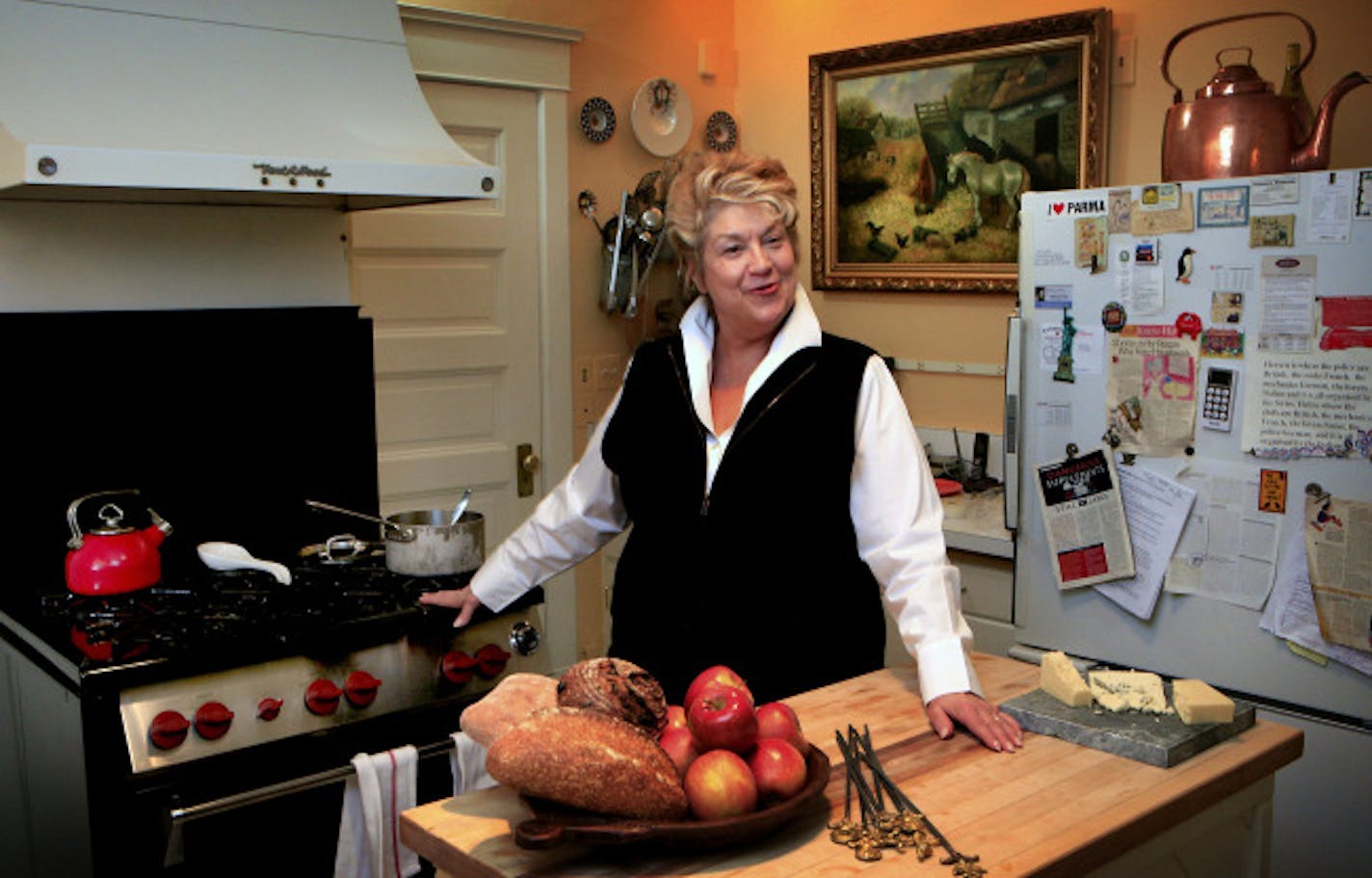 One of Lynn Rossetto Kasper's favorite rooms is her kitchen, which is only fitting for someone who writes cookbooks, has a cooking show on NPR, and loves to entertain. But her look and feel is casual, as can be seen by her note cover refrigerator. The 18,000 BTU Wolf stove behind her was purchased with her first royalty check from her book "The Splendid Table", and she calls it "Babe."