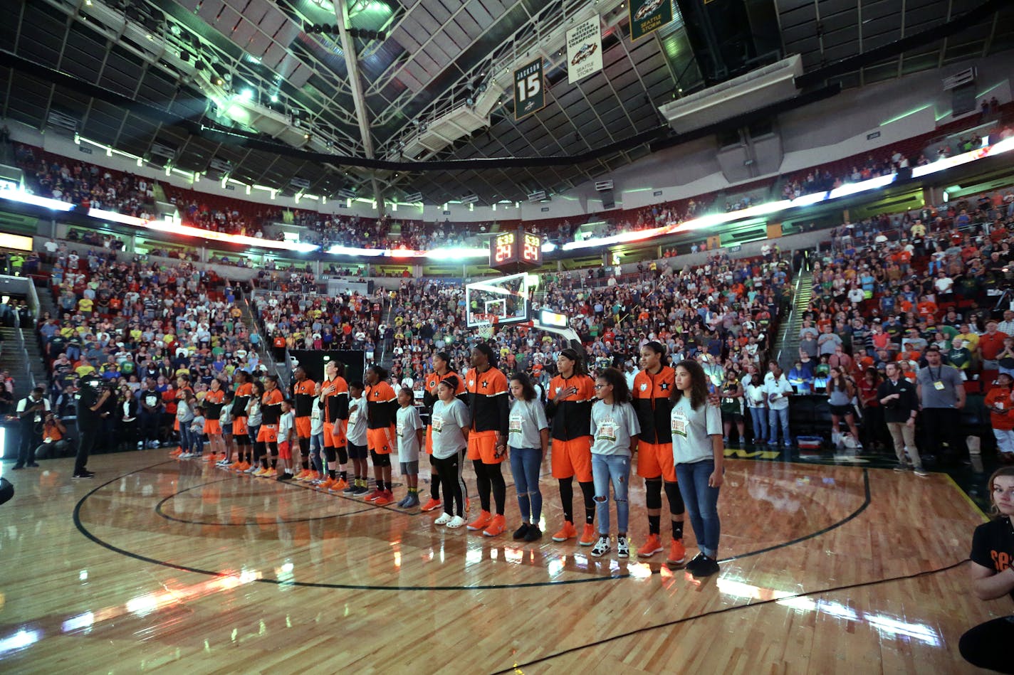 Western Conference players stand with children during the national anthem before the WNBA All-Star basketball game Saturday, July 22, 2017, in Seattle. (AP Photo/Elaine Thompson) ORG XMIT: OTK