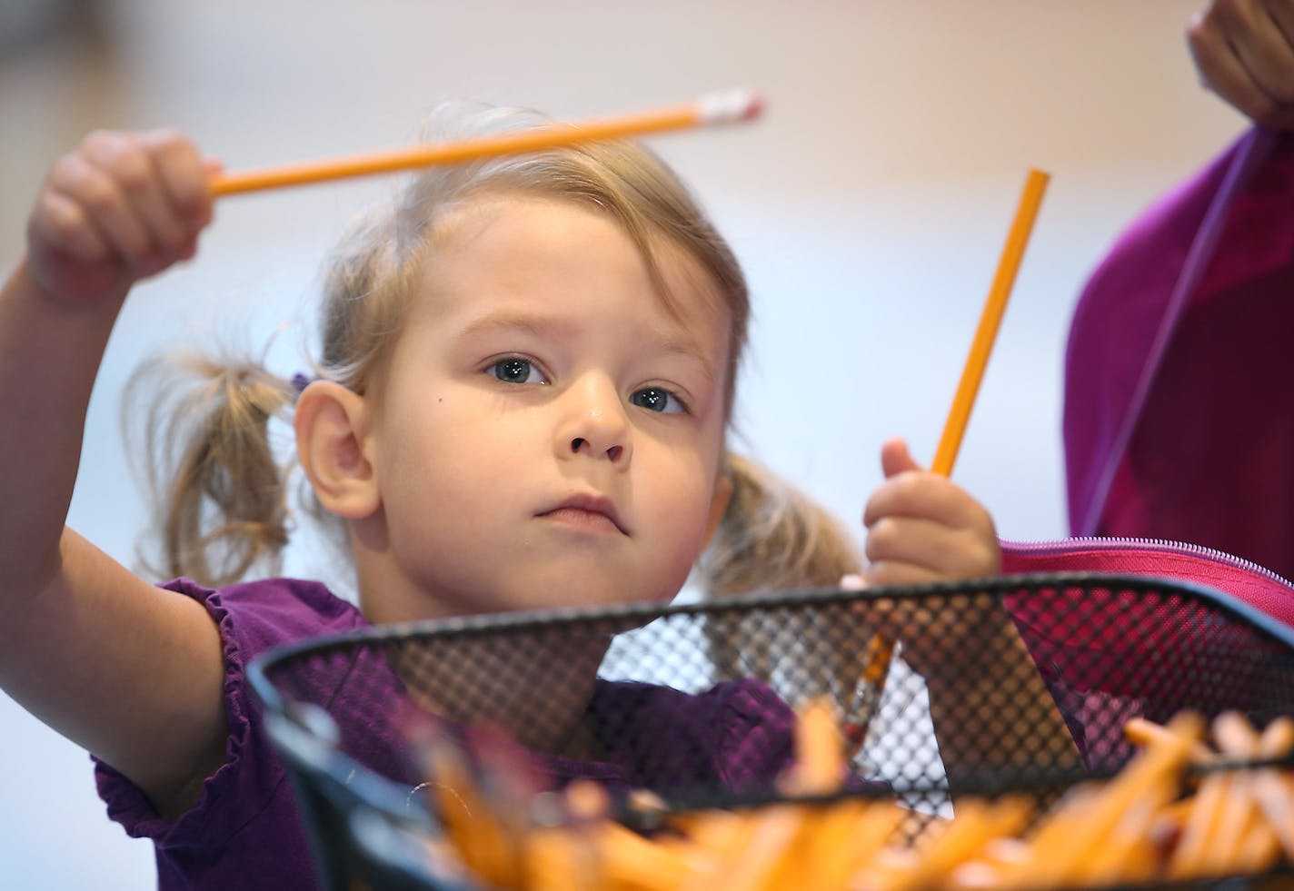 Three-year-old Sophie Arness, who was there with her mother Nikki Arness, grabbed school supplies to fill a backpack at the Mall of America rotunda, Tuesday, August 18, 2015 in Bloomington, MN. They joined many families to help fill five hundred kindergarten-ready backpacks to be distributed to local students. ] (ELIZABETH FLORES/STAR TRIBUNE) ELIZABETH FLORES &#x2022; eflores@startribune.com