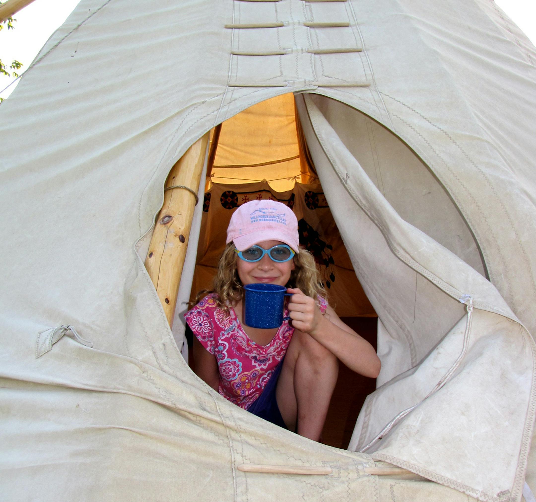 PHOTO BY LISA MEYERS McCLINTICK Kylie McClintick settles into a night in a tipi on southwest Minnesota‚Äôs prairie. Upper Sioux Agency State Park