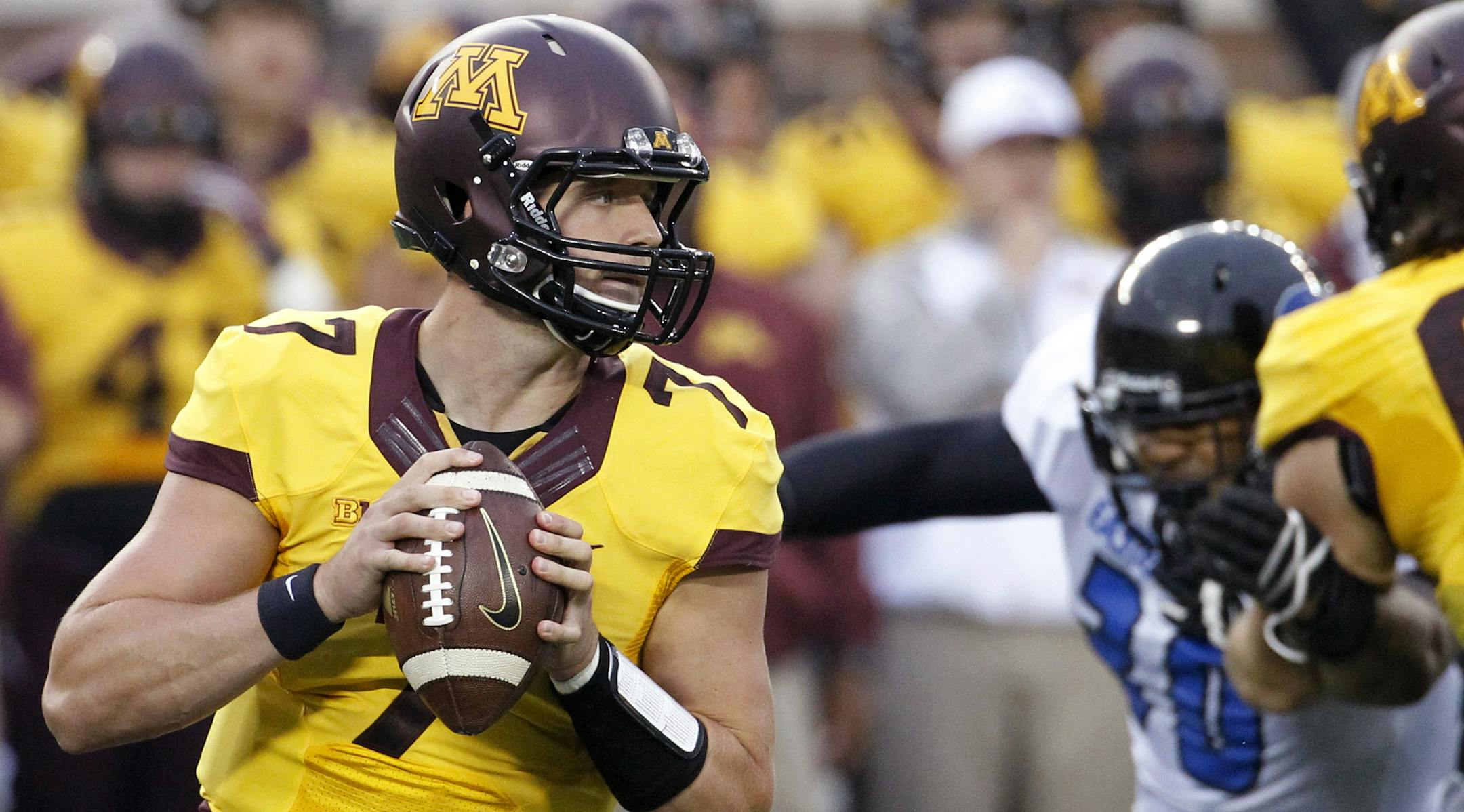 Minnesota quarterback Mitch Leidner (7) drops back for a pass against Eastern Illinois during the first quarter of an NCAA college football game in Minneapolis Thursday, Aug. 28, 2014. (AP Photo/Ann Heisenfelt) ORG XMIT: MIN2014090219135467