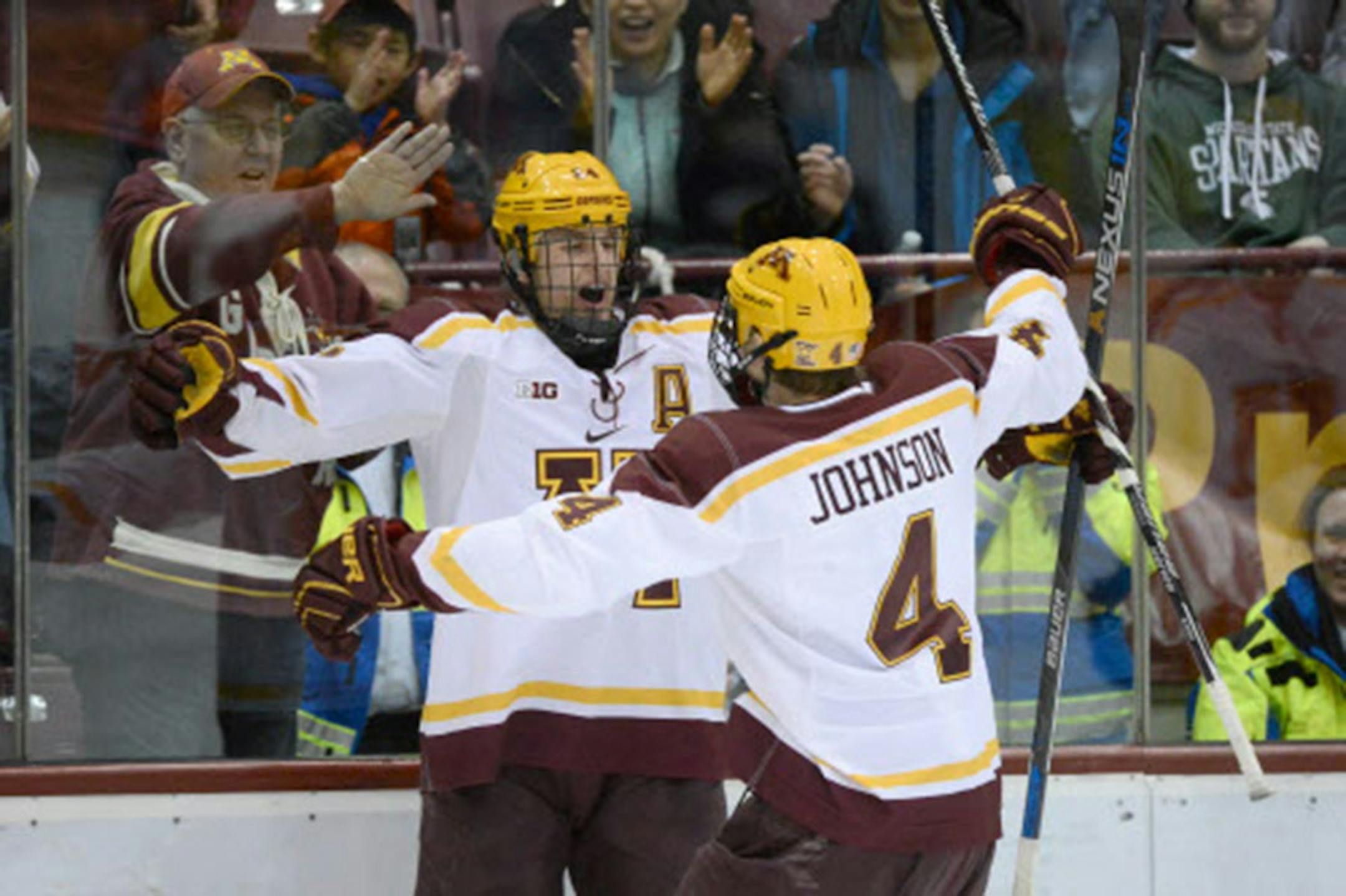 Gophers defenseman Steve Johnson (4) celebrated with right wing Hudson Fasching (24) after a goal scored by Fasching earlier this season.
