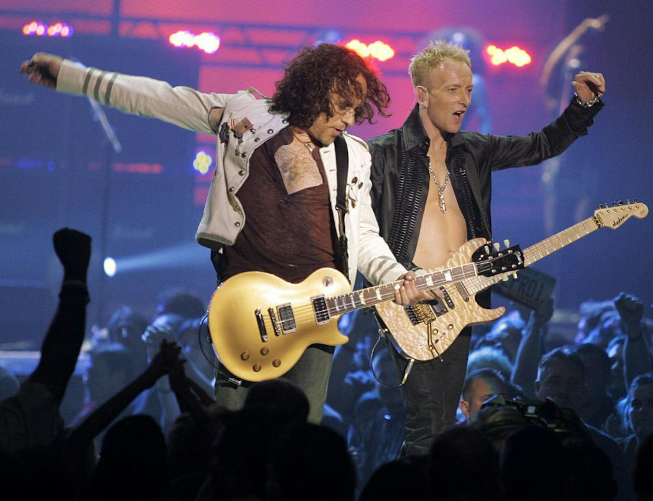 FILE - In a May 25, 2006, file photo Vivian Campbell, left, and Phil Collen, right, of rock group Def Leppard perform in Las Vegas. In a statement Monday, June 10, 2013, Campbell reveals he has Hodgkin's Lymphoma and has been in chemotherapy for two months, with four months to go.