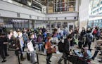 Passengers wait in line to go through the new north security checkpoint at Terminal 1 of Minneapolis-St. Paul International Airport. ] (Leila Navidi/S