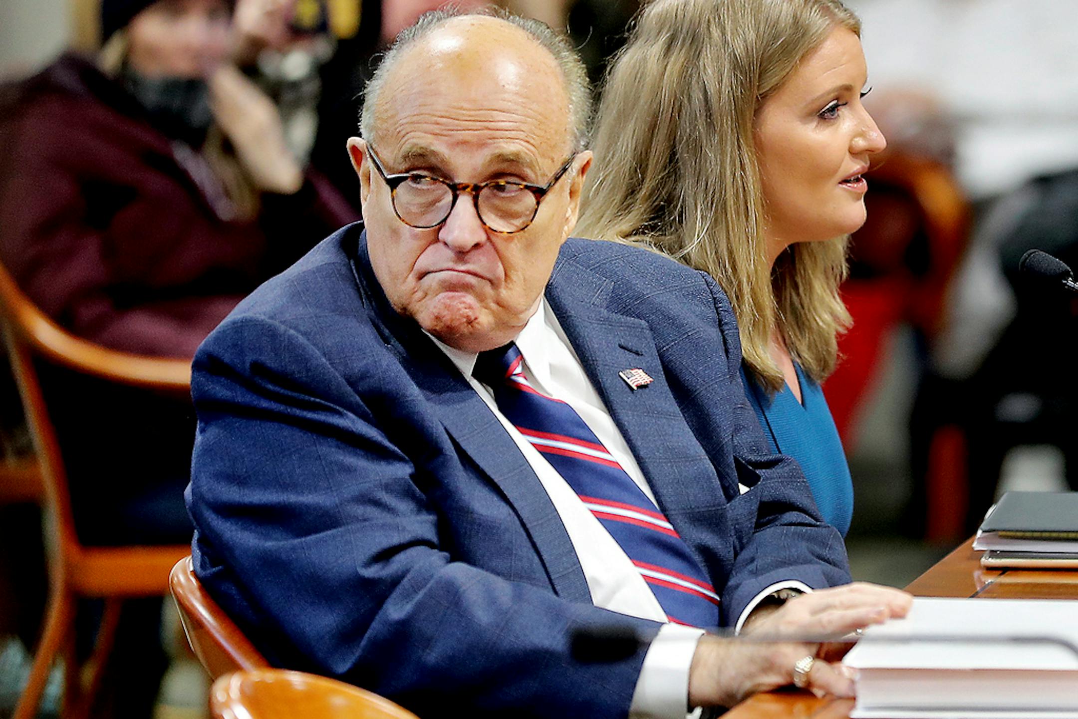 FILE - In this Dec. 2, 2020, file photo, Rudy Giuliani, President Donald Trump's personal attorney, scans the room during a Michigan House Oversight Committee hearing on suspicion of voter fraud within the state at the House Office Building in Lansing, Mich. Federal agents raided Giuliani's Manhattan home and office on Wednesday, April 28, 2021, seizing computers and cellphones in a major escalation of the Justice Department's investigation into the business dealings of former President Donald Trump's personal lawyer. (Mike Mulholland/The Grand Rapids Press via AP)