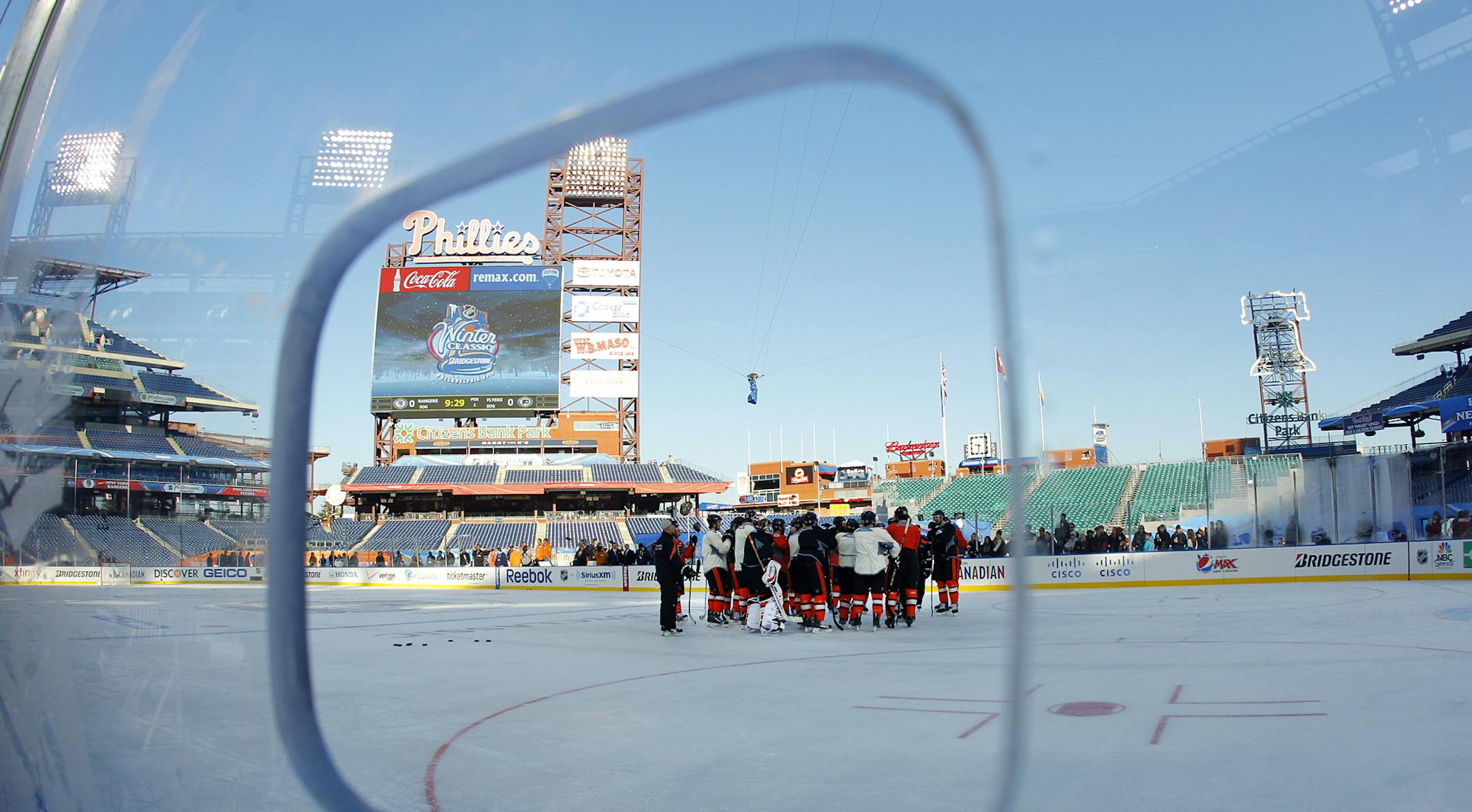 The Philadelphia Flyers gather on the ice during practice for the Winter Classic hockey game, Sunday, Jan. 1, 2012, in Philadelphia. The Flyers are slated host the New York Rangers outdoors on Monday. (AP Photo/Tom Mihalek) ORG XMIT: PATM107
