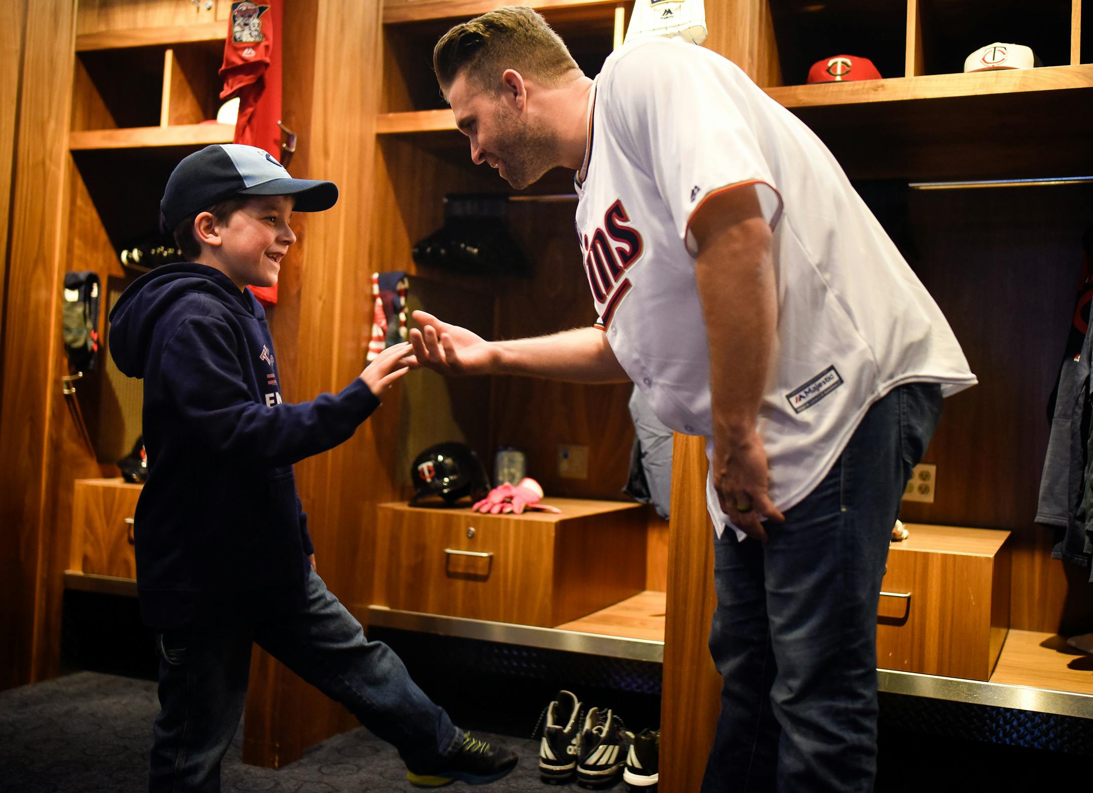 Twins second baseman Brian Dozier high fived Zach Hodgson, 7, of Bloomington