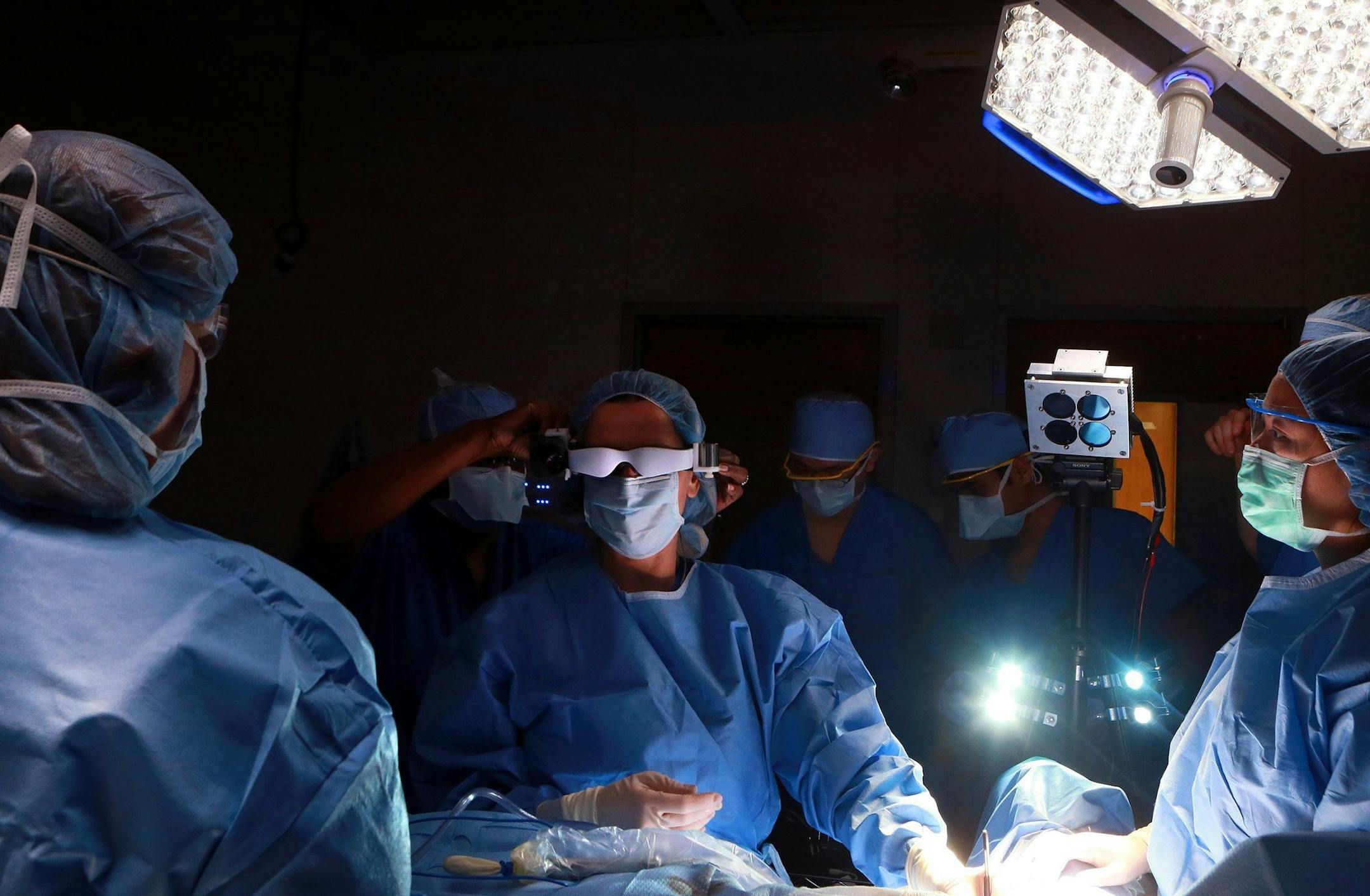 Julie Margenthaler, center, a Washington University breast surgeon at the Siteman Cancer Center in St. Louis, prepares to perform an operation on Feb. 10, 2014, to remove a lymph node on 67-year-old Karen Clodfelter using a type of visual device that can see a fluorescent compound injected into the tissue that gives a more accurate view of potential tumors. (Christian Gooden/St. Louis Post-Dispatch/MCT)