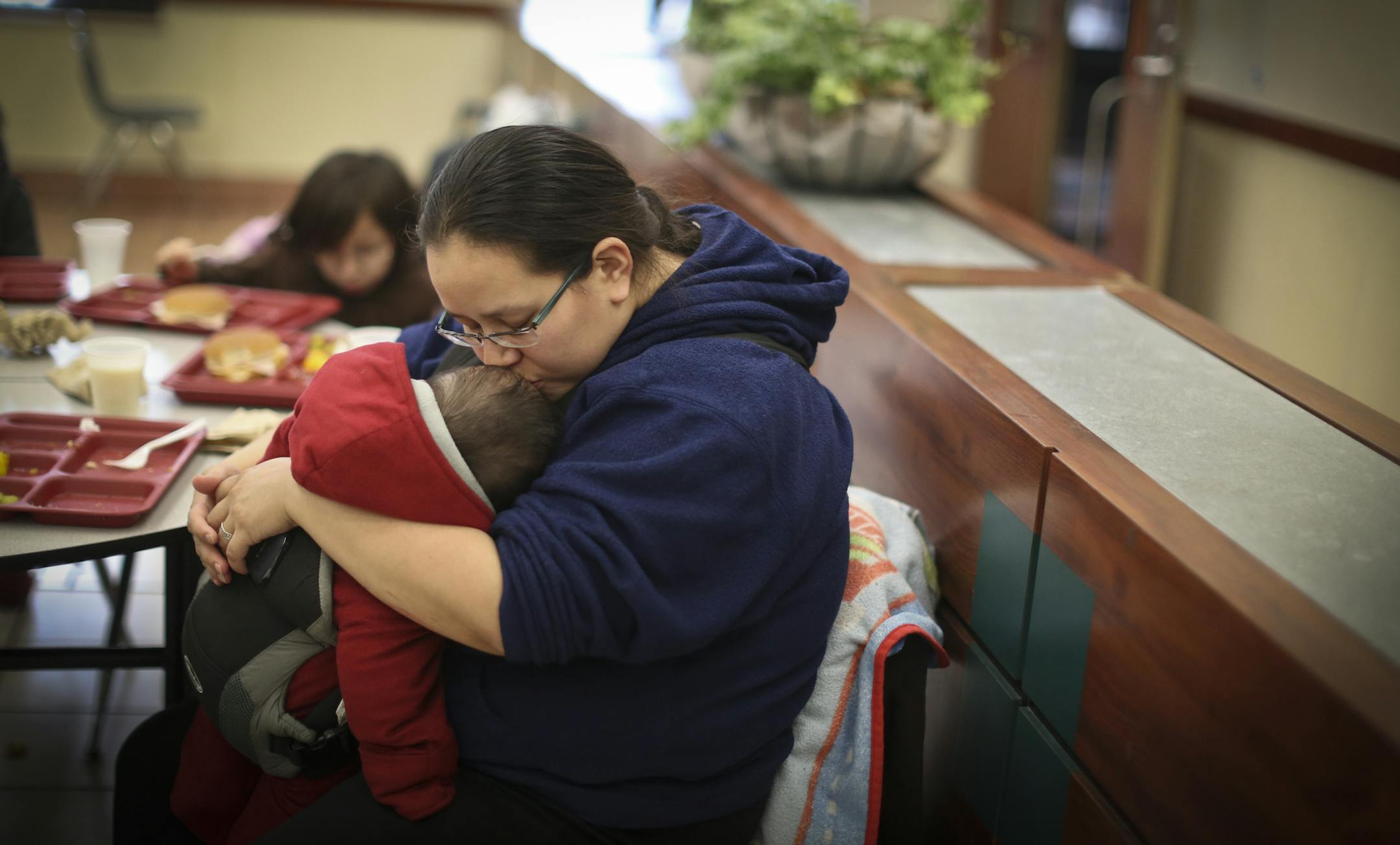 Darcie Cleveland kissed her son Brandon Jr. as she ate dinner with family members at the Dorothy Day Center in St. Paul, Minn. on Thursday, May 2, 2013. Cleveland dosen't sleep at the shelter but eats there regularly. ] (RENEE JONES SCHNEIDER * reneejones@startribune.com)