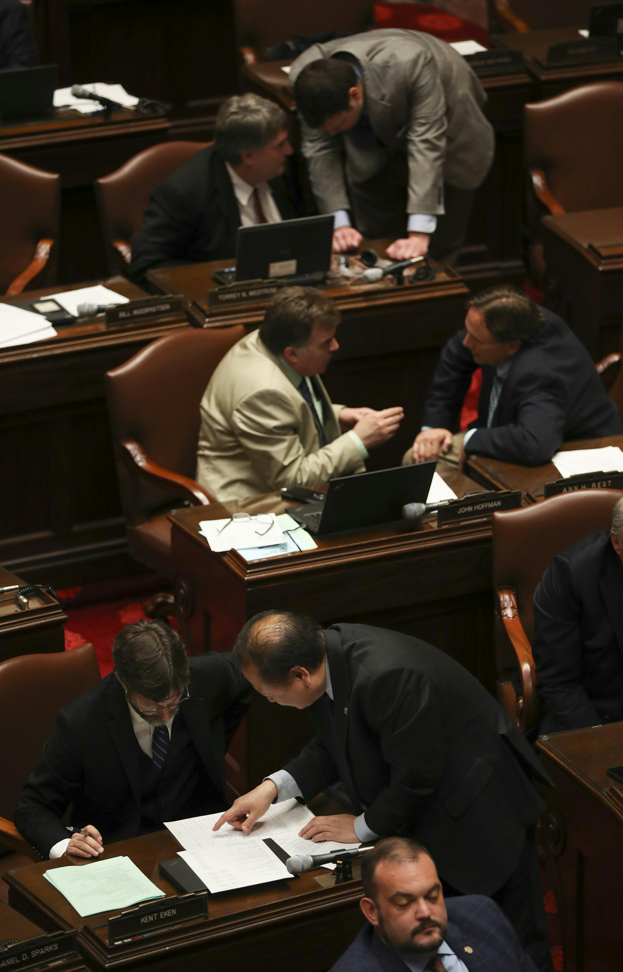 Senators conferred in pairs while other members discussed the Omnibus Higher Education Bill Sunday afternoon. Foreground to background, they are, Sen. Kent Eken, DFL - Win Valley, left, with Foung Hawj, DFL - St. Paul, John Hoffman, DFL - Champlin, left, with Sen. Jim Abeler, R - Anoka, and Sen. Torrey Westrom, R - Elbow Lake, left, with Senate researcher Andrew Larson ] JEFF WHEELER ï jeff.wheeler@startribune.com With just a day left in the session, the Minnesota legislature was busy Sunda