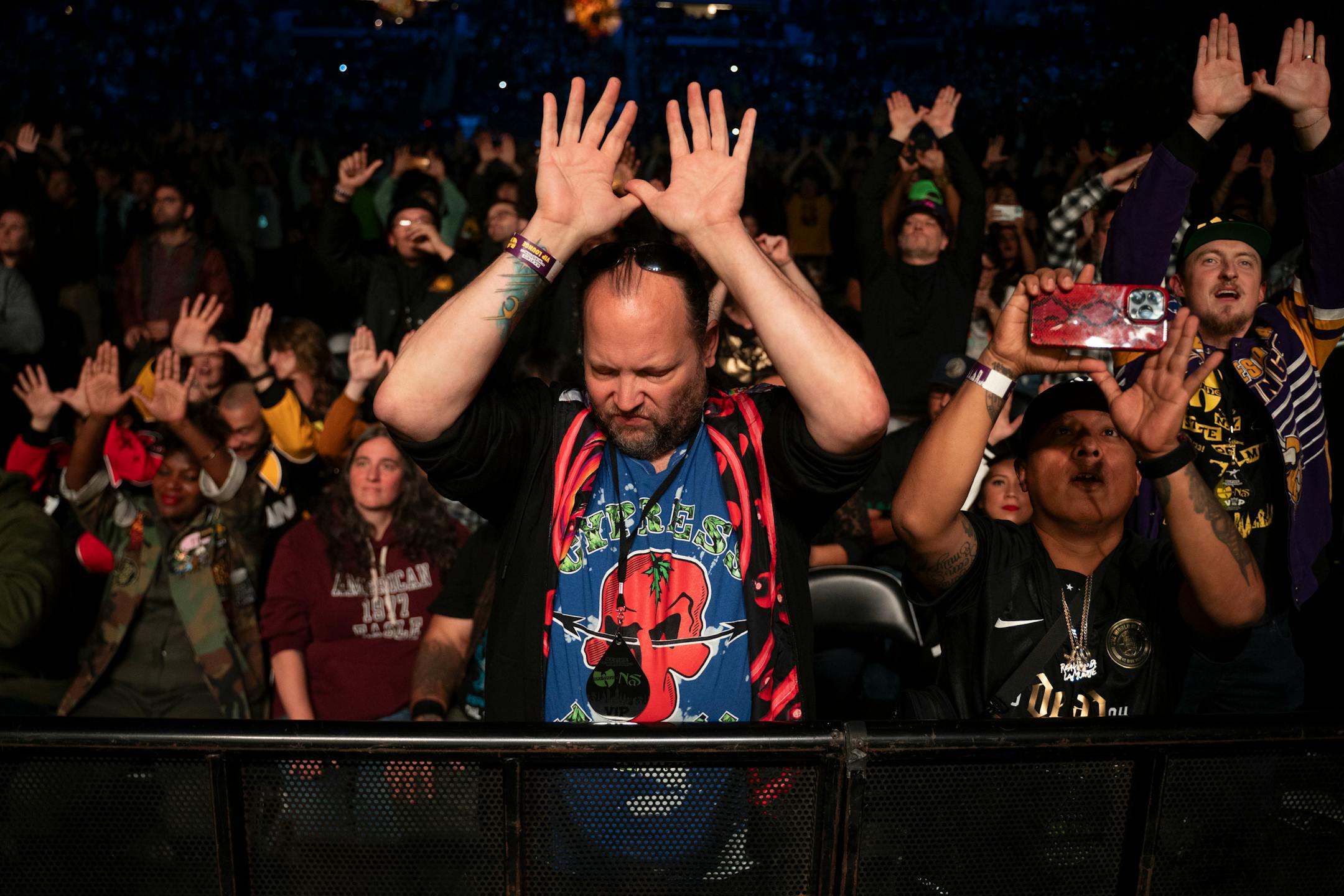 A fan holds up the Wu-Tang Clan hand sign during the group's performance.