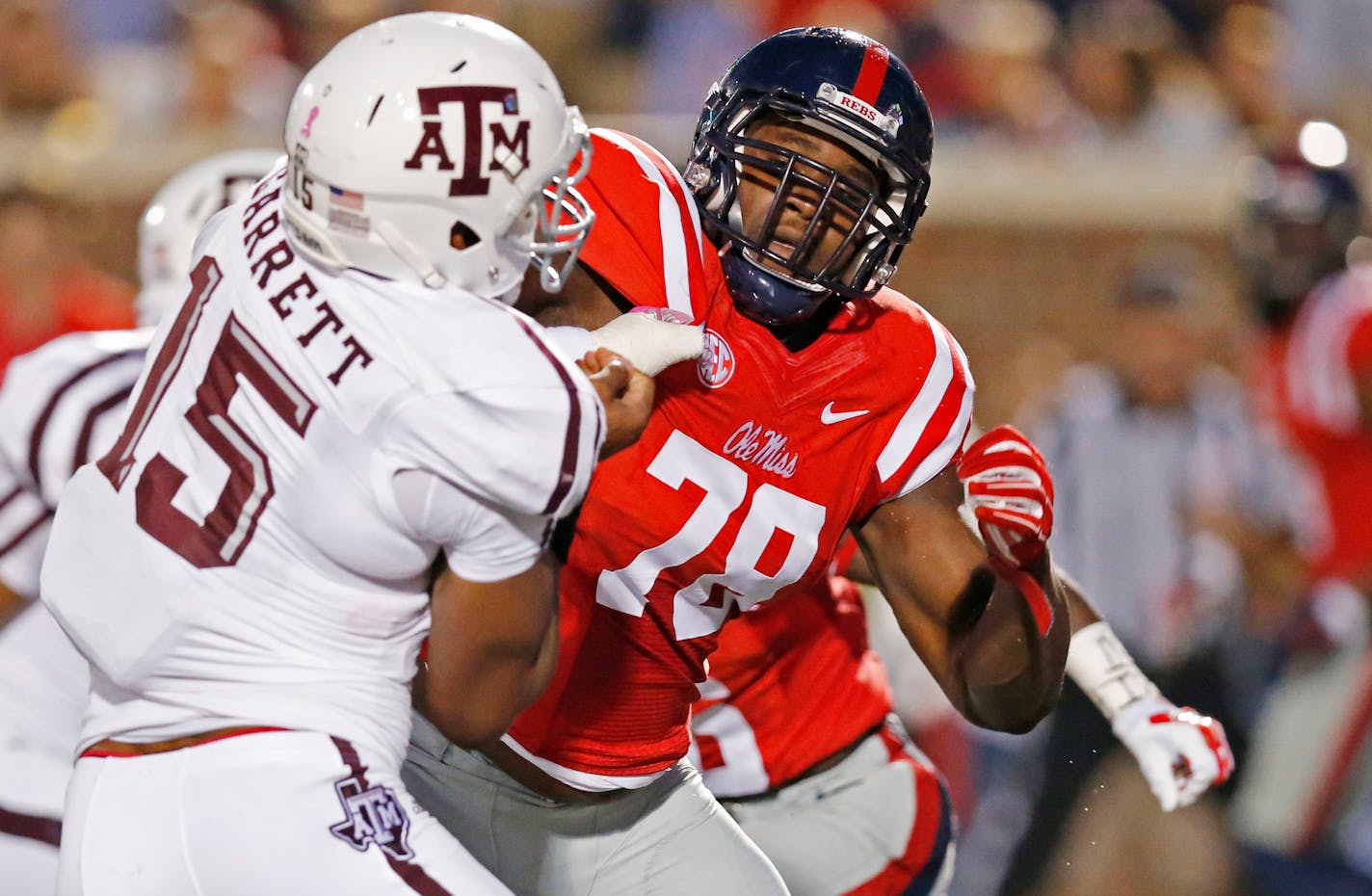 FILE - In this Oct. 24, 2015, file photo, Texas A&M defensive lineman Myles Garrett (15) is blocked by Mississippi offensive lineman Laremy Tunsil (78) during the first half of their NCAA college football game in Oxford, Miss. Tunsil is one of the top offensive players available in the NFL Draft, which starts April 28 in Chicago. (AP Photo/Rogelio V. Solis, File)