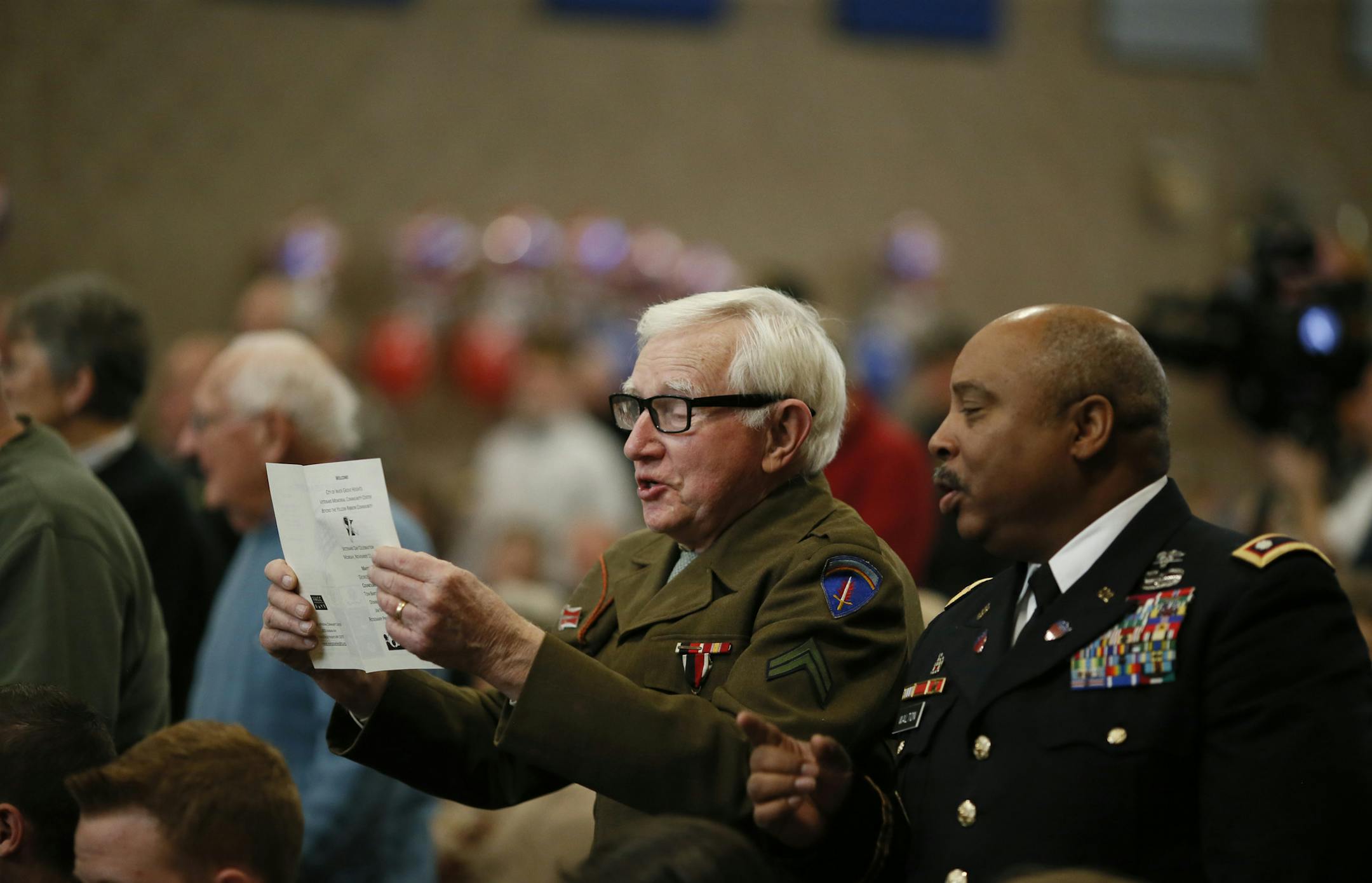 Retired army veterans Cpl. Hugh O'Kane, left, and Lt. Col. Mike Walton sung the Army's song during Veterans Day observance at Veterans Memorial Community Center Monday in Inver Grove Heights.