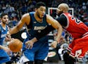Minnesota Timberwolves� Karl-Anthony Towns, left, drives on Chicago Bulls� Taj Gibson in the second half of an NBA basketball game, Saturday, Feb.