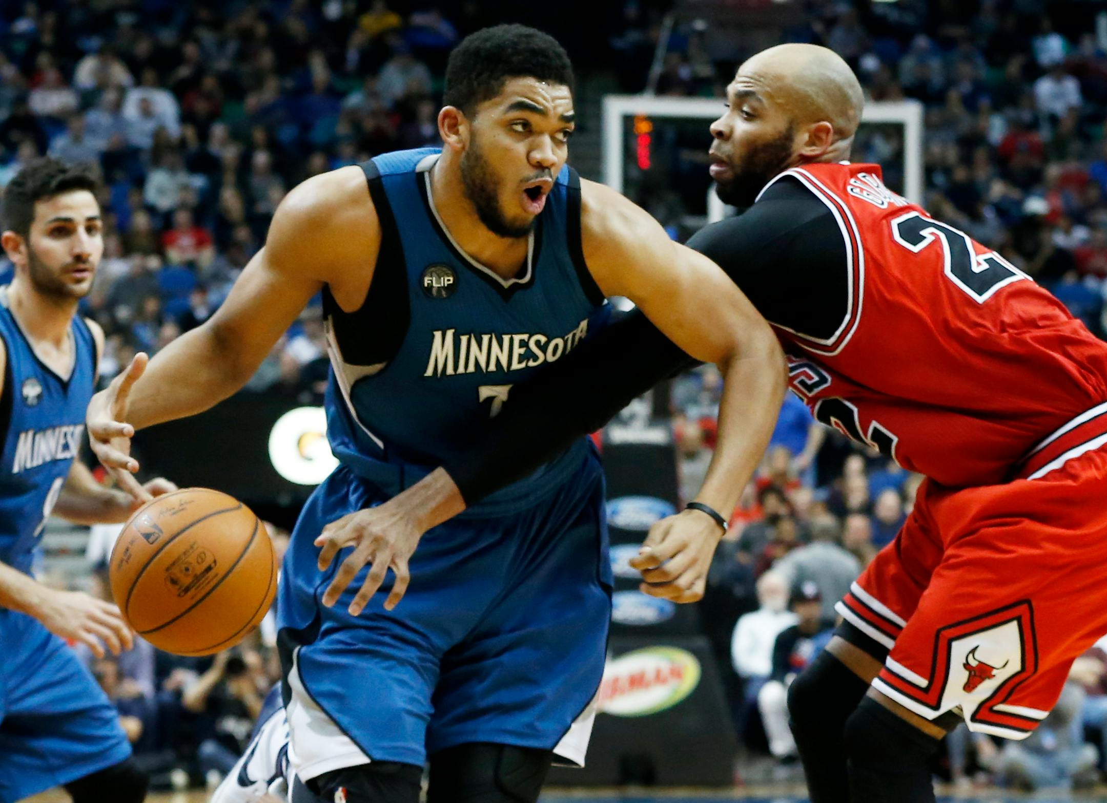 Minnesota Timberwolves� Karl-Anthony Towns, left, drives on Chicago Bulls� Taj Gibson in the second half of an NBA basketball game, Saturday, Feb. 6, 2016, in Minneapolis. The Timberwolves won 112-105. (AP Photo/Jim Mone)