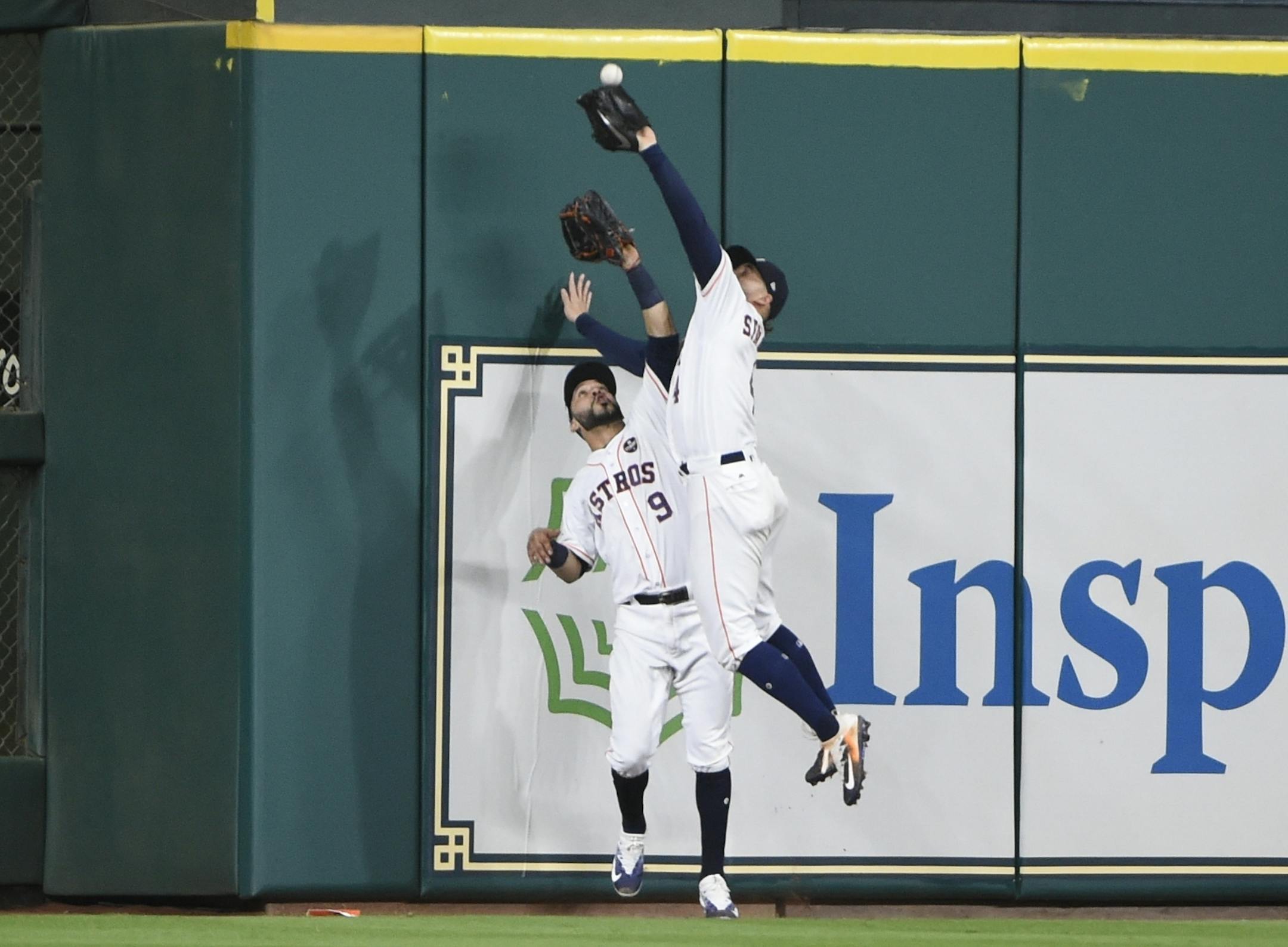 Houston Astros' George Springer catches a fly ball hit by New York Yankees' Greg Bird in front of Marwin Gonzalez during the seventh inning of Game 7 of baseball's American League Championship Series Saturday, Oct. 21, 2017, in Houston. (AP Photo/Eric Christian Smith)
